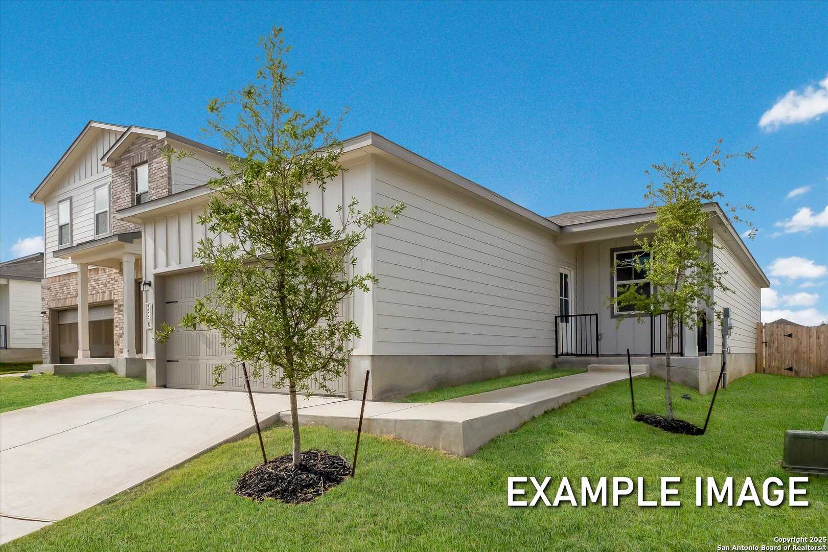 Modern 1-story beige home with stone accents, 2-car garage, young trees, and lush lawn in Agave, San Antonio, Texas - Davidson Homes The Comal B