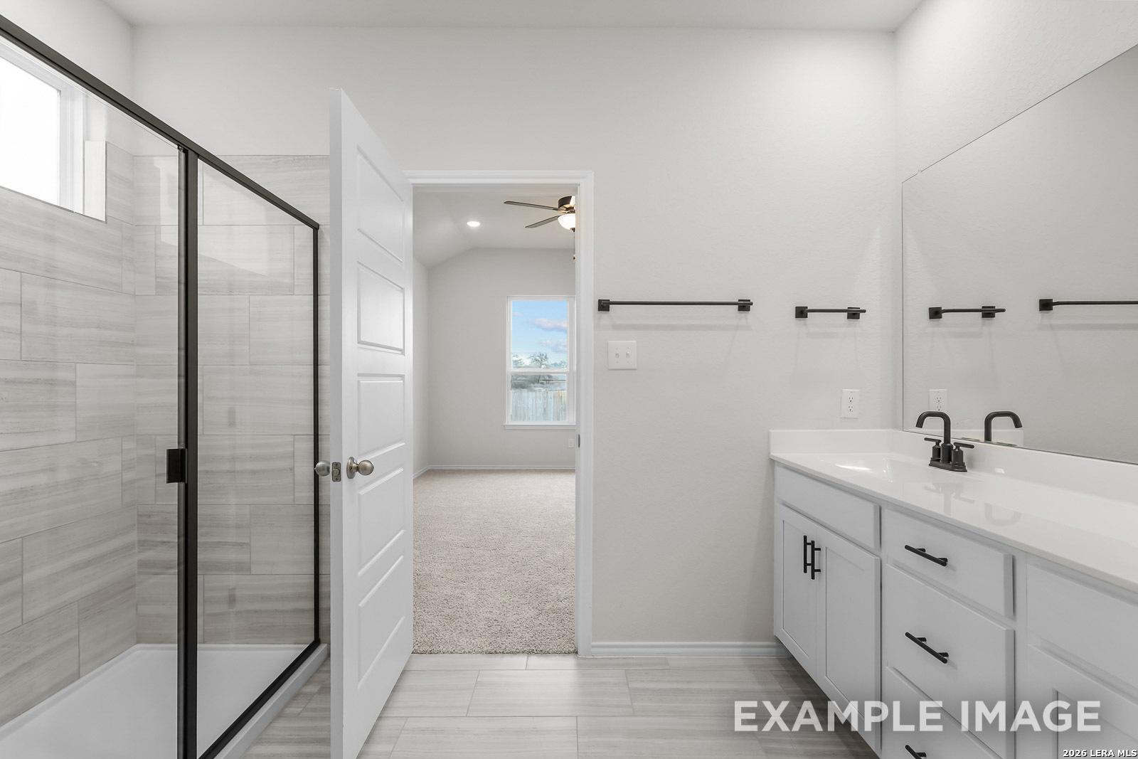 Modern bathroom with walk-in shower and white vanity in The Sequoia C floor plan by Davidson Homes, San Antonio, Texas.