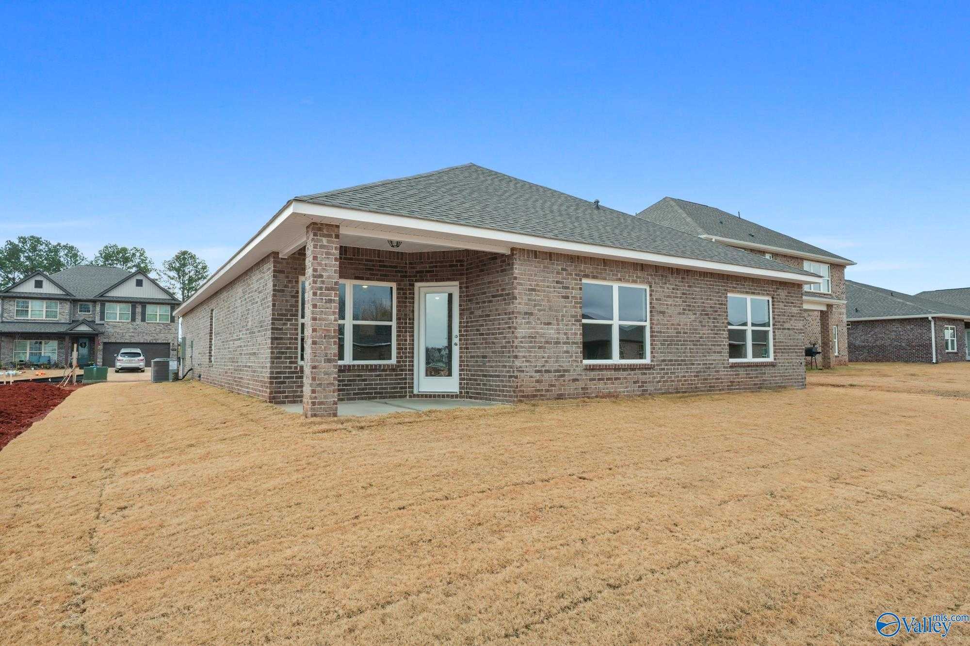 Single-story brick home with covered front porch, gabled roof, and large windows in Ricketts Farm, Athens, Alabama - Davidson Homes The Daphne D