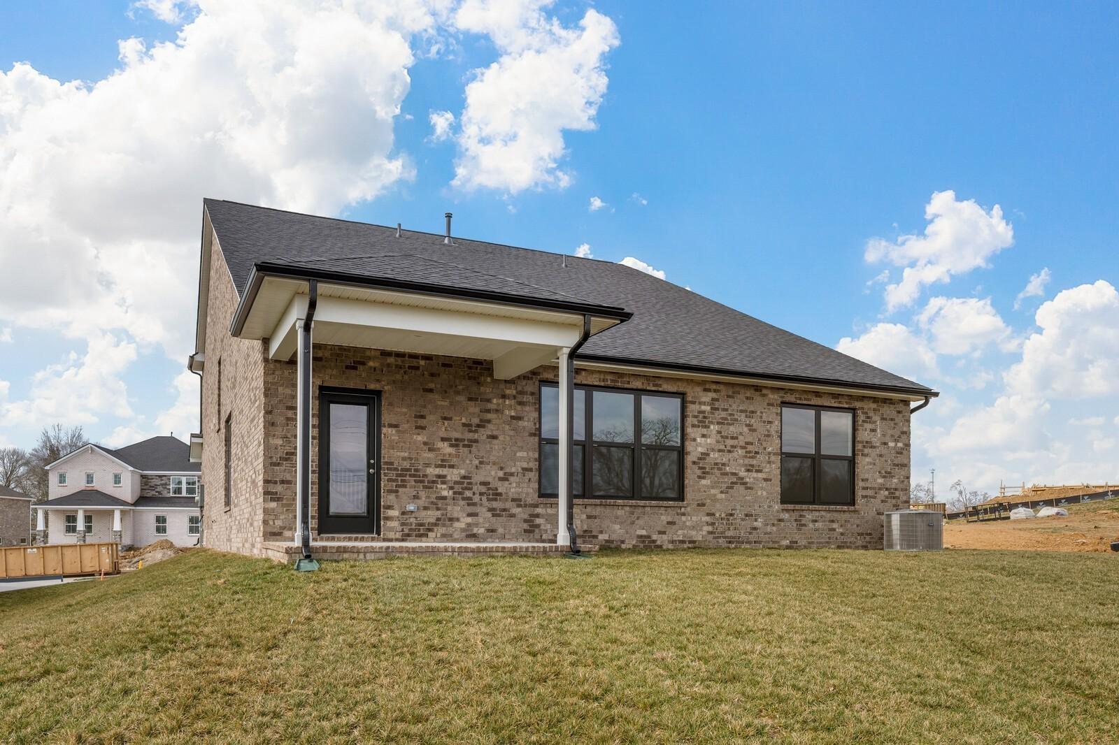 Brick exterior and covered back patio of The Ridgeport D floor plan by Davidson Homes in Benders Cove, Mt. Juliet, TN.