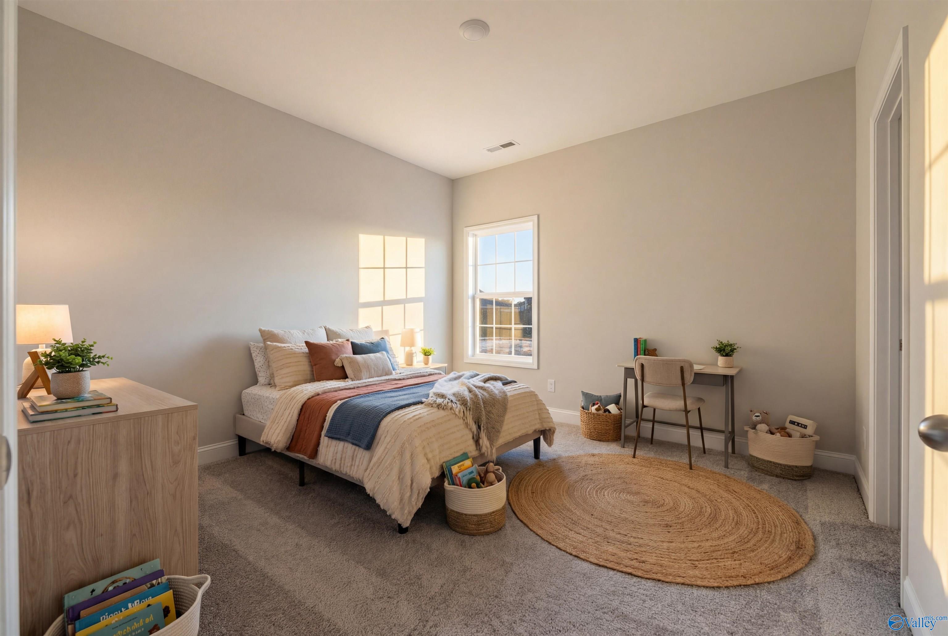 Cozy bedroom with queen bed, orange accents, desk, plants, and window light in Davidson Homes The Montgomery B, Toney, Alabama