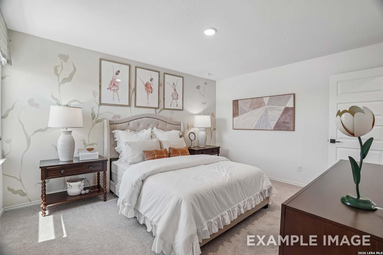 Cozy bedroom with upholstered headboard, floral accent wall, and dark wood nightstands in Davidson Homes Pinecrest F, San Antonio TX