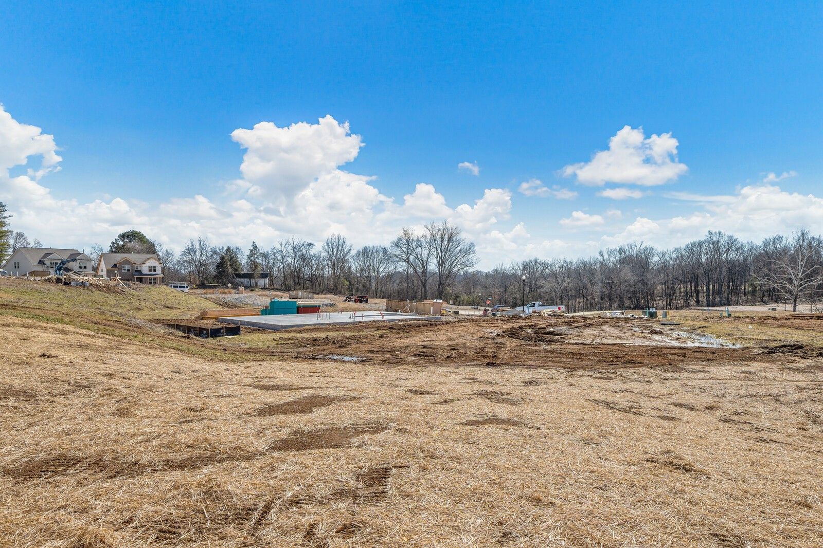 Scenic construction site with pond excavation and wooded hills in Woods Crossing, Gallatin, Tennessee for Davidson Homes The Ash A