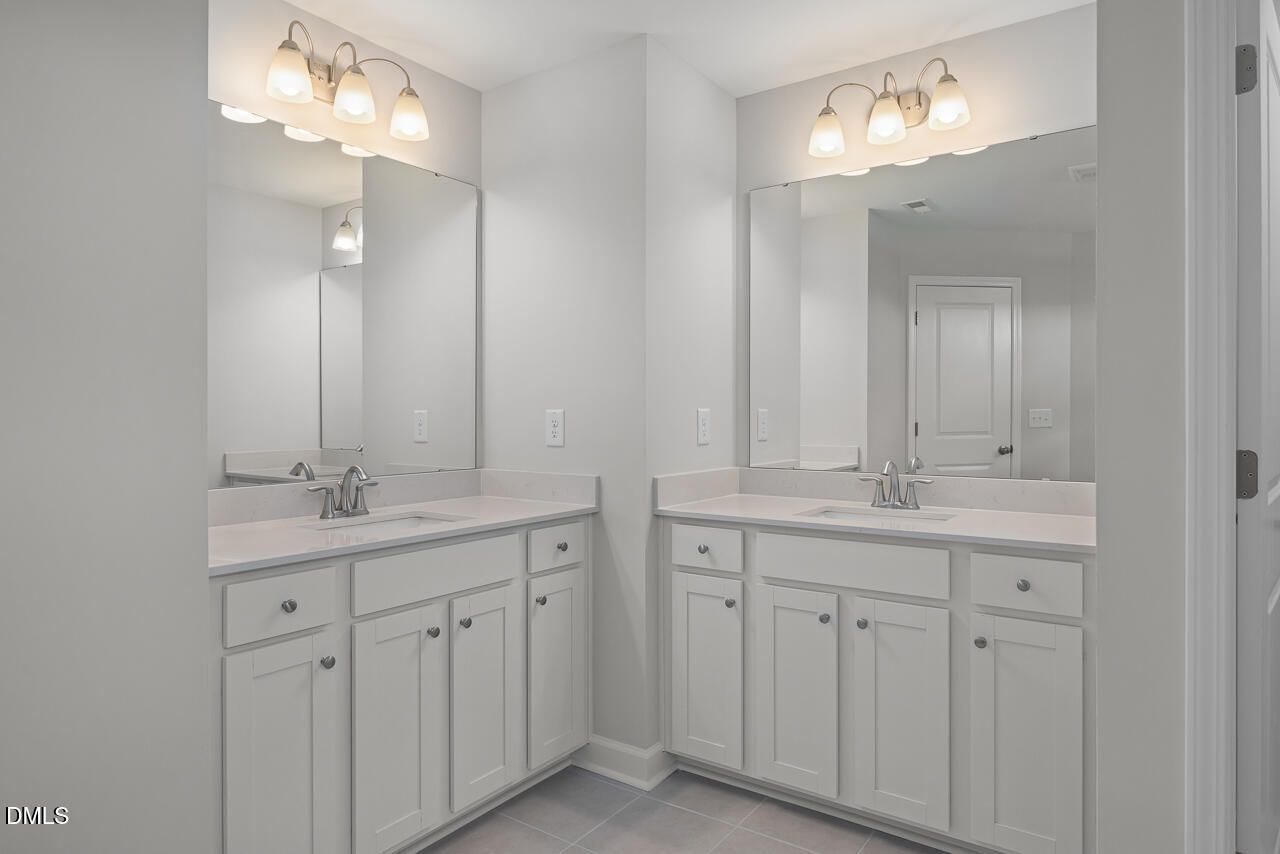Modern dual vanity with white cabinets and quartz countertops in The Graham Interior floor plan by Davidson Homes.