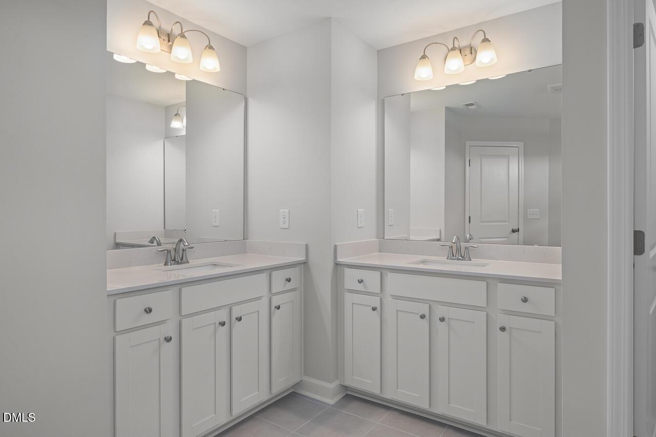 Modern dual vanity with white cabinets and quartz countertops in The Graham Interior floor plan by Davidson Homes.