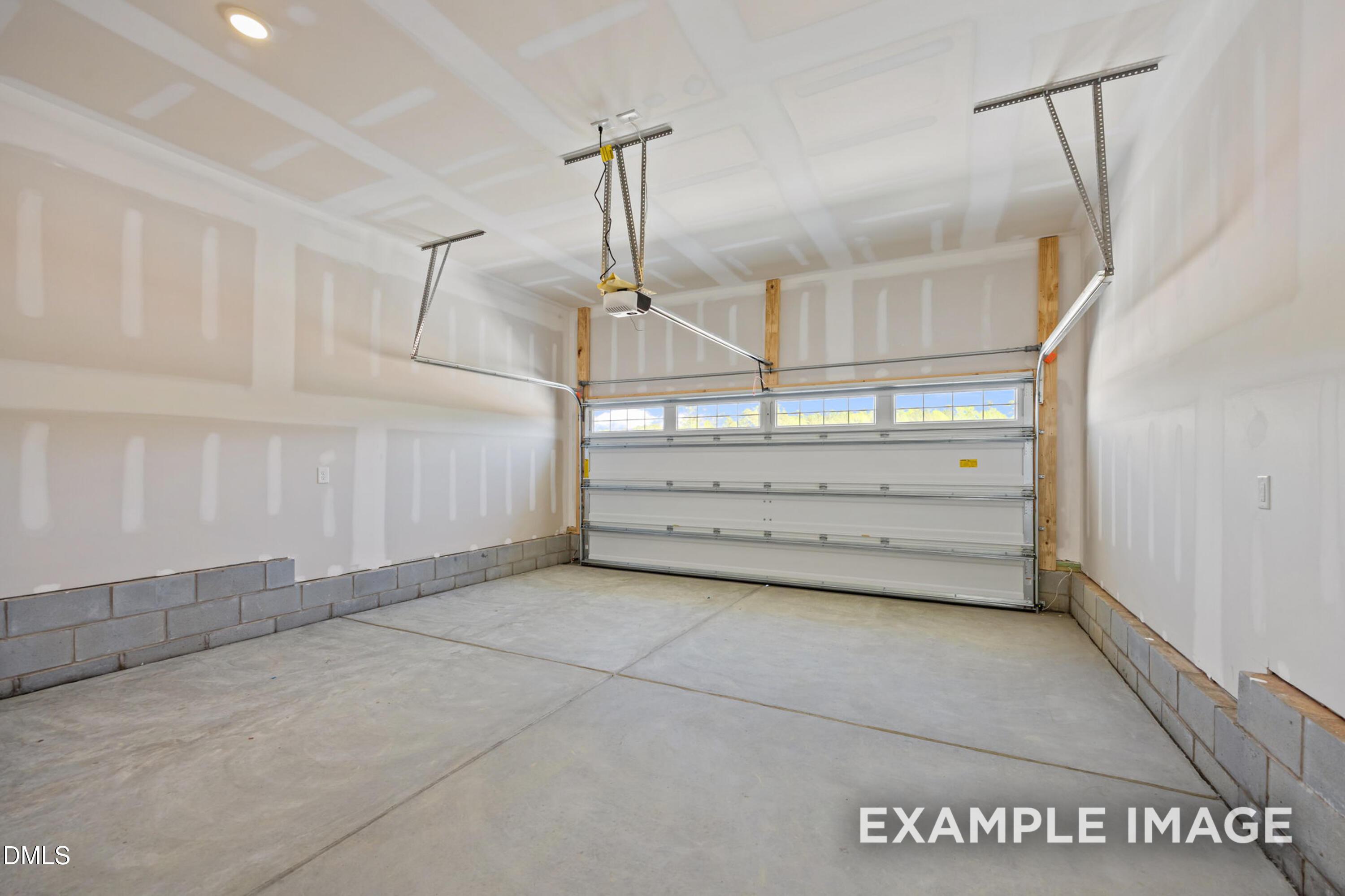 Spacious 2-car garage with unfinished drywall in The Alexander B floor plan by Davidson Homes in Knightdale, NC.
