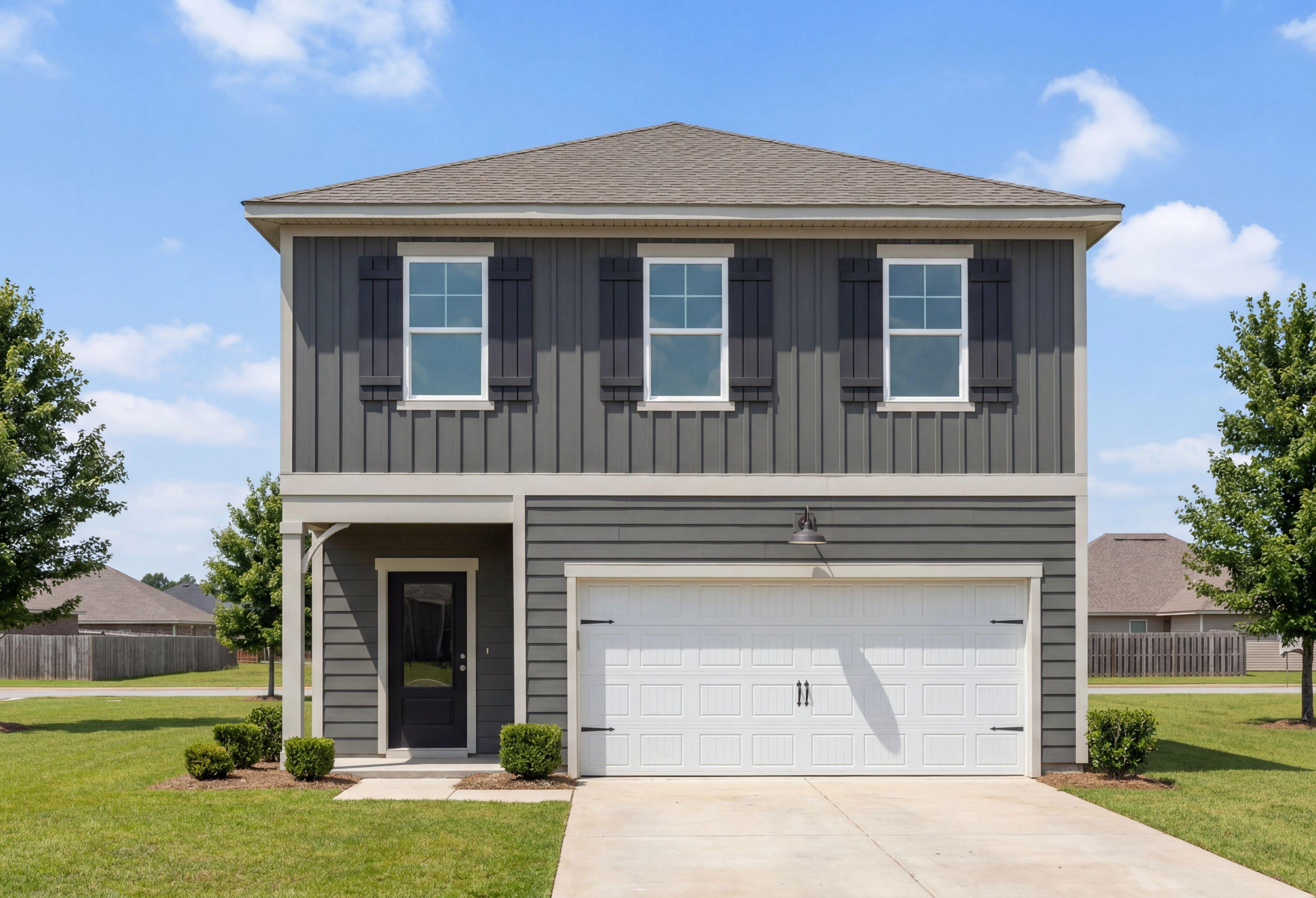 Two-story exterior of The Burton B home design in Cullman, Alabama featuring dark gray siding and a two-car garage.