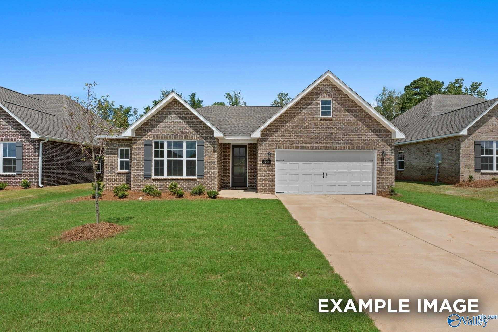 Charming 1-story brick ranch home with 2-car garage, shutters, and landscaped yard in Davidson Homes The Montgomery, Pikes Ridge, Meridianville, Alabama