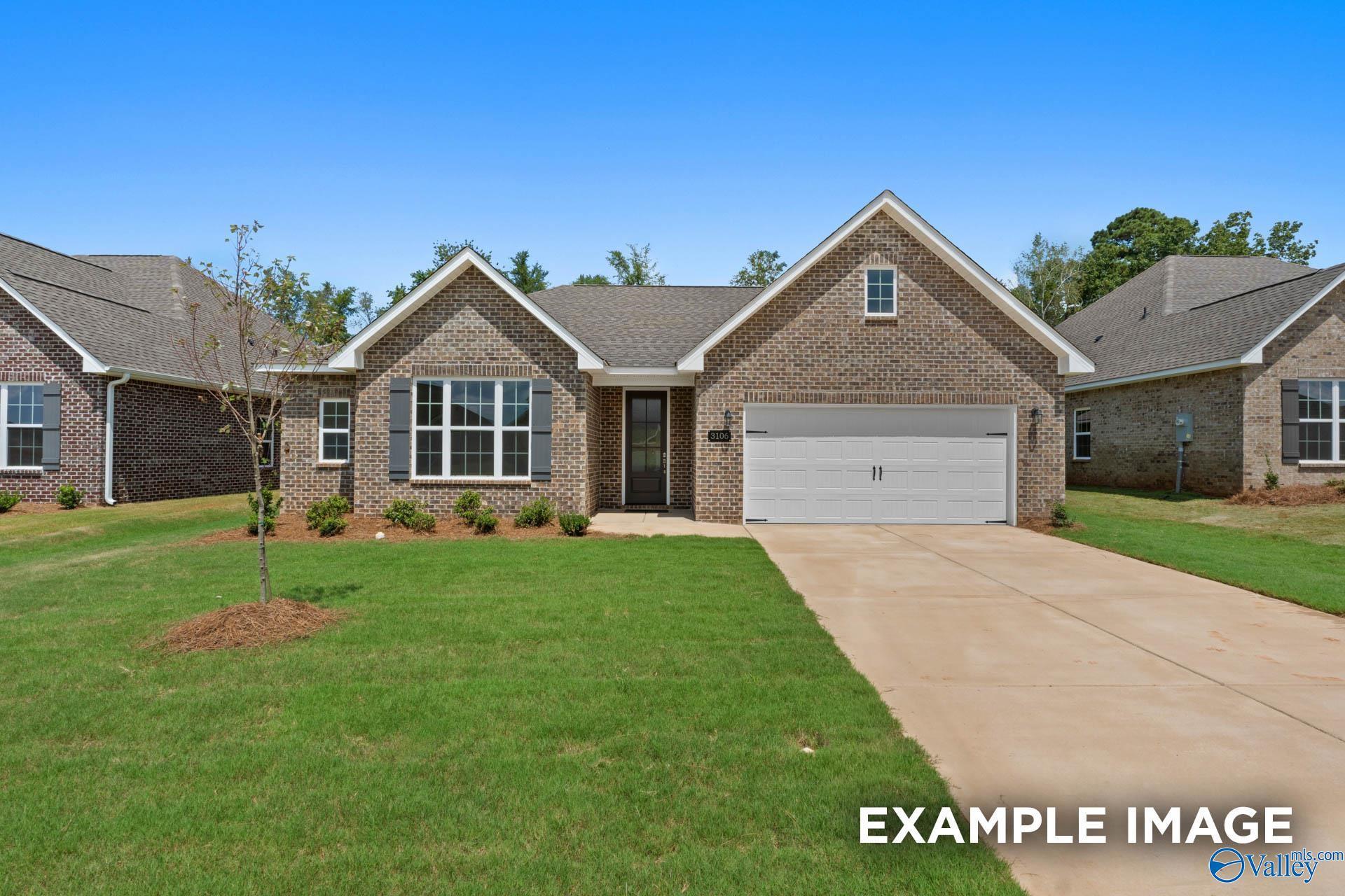 Charming 1-story brick ranch home with 2-car garage, shutters, and landscaped yard in Davidson Homes The Montgomery, Pikes Ridge, Meridianville, Alabama