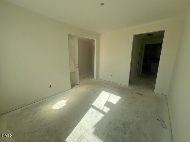 Empty unfinished room with sunlight streaming through windows in The Magnolia II B home by Davidson Homes in Lillington, NC