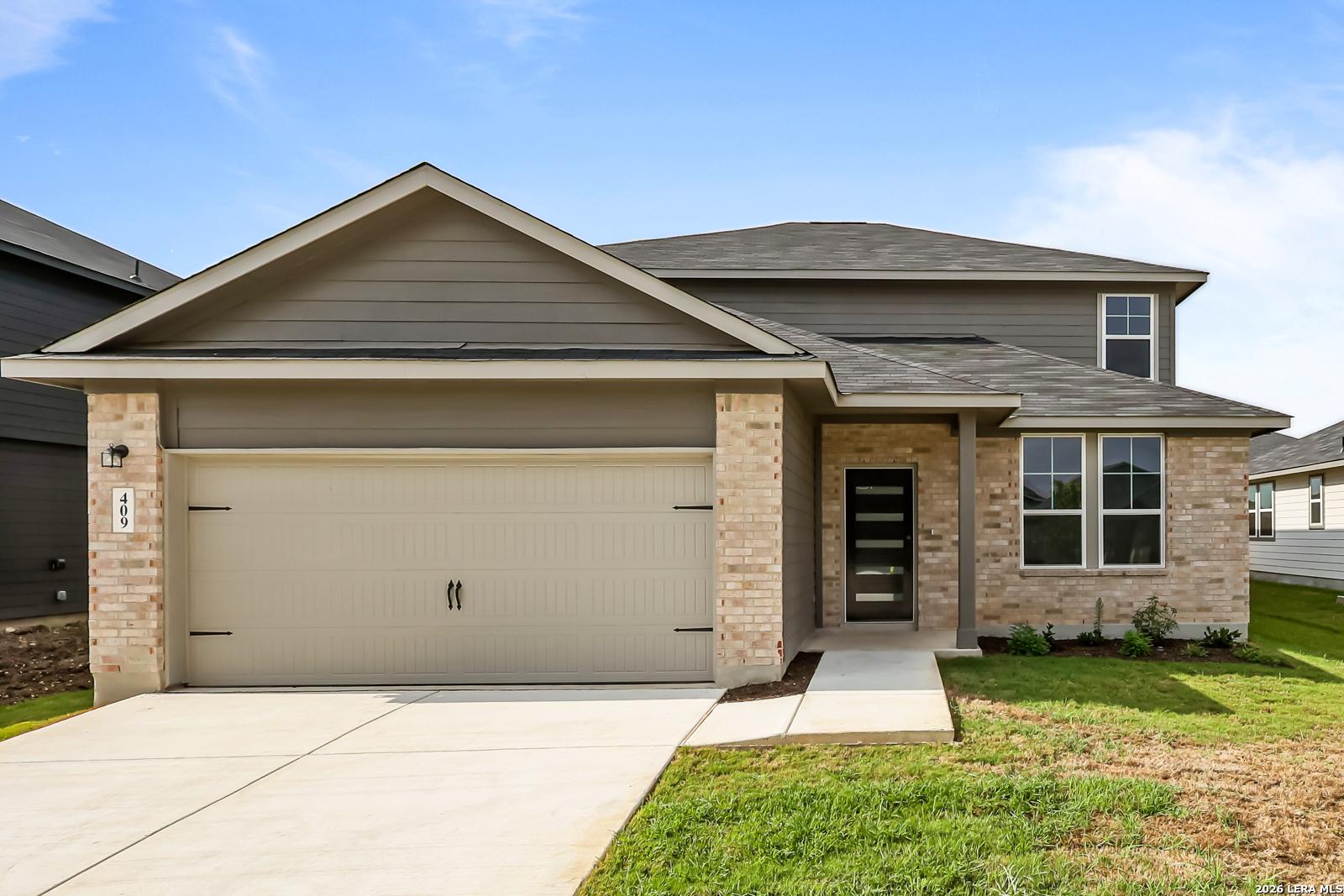 Two-story Douglas C floor plan by Davidson Homes with brick and siding exterior in Hannah Heights, Seguin, Texas.