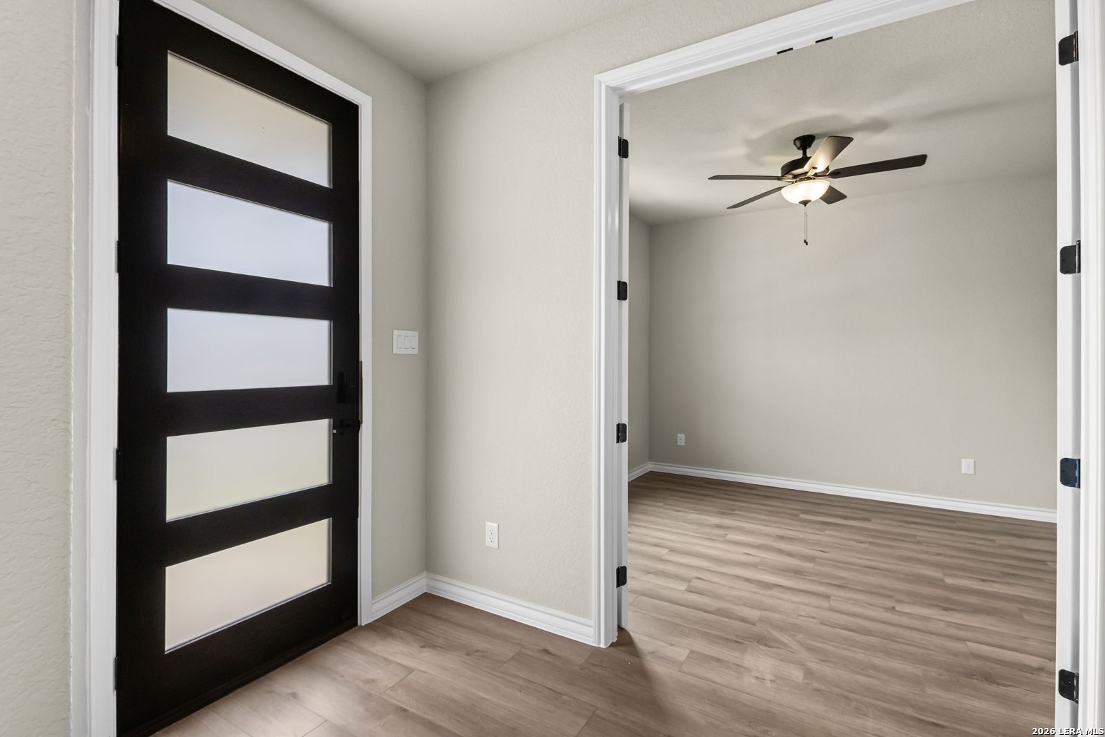 Modern home office with French doors and ceiling fan in The Danbury H floor plan at The Reserve at Potranco Oaks.