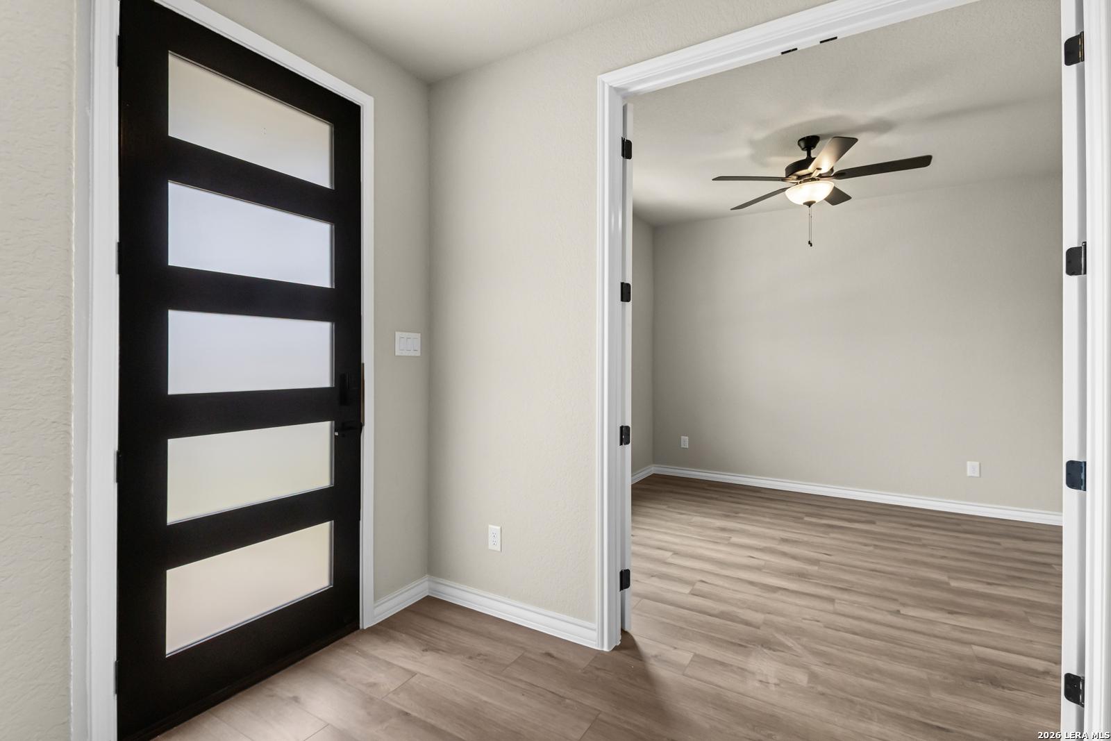 Modern home office with French doors and ceiling fan in The Danbury H floor plan at The Reserve at Potranco Oaks.