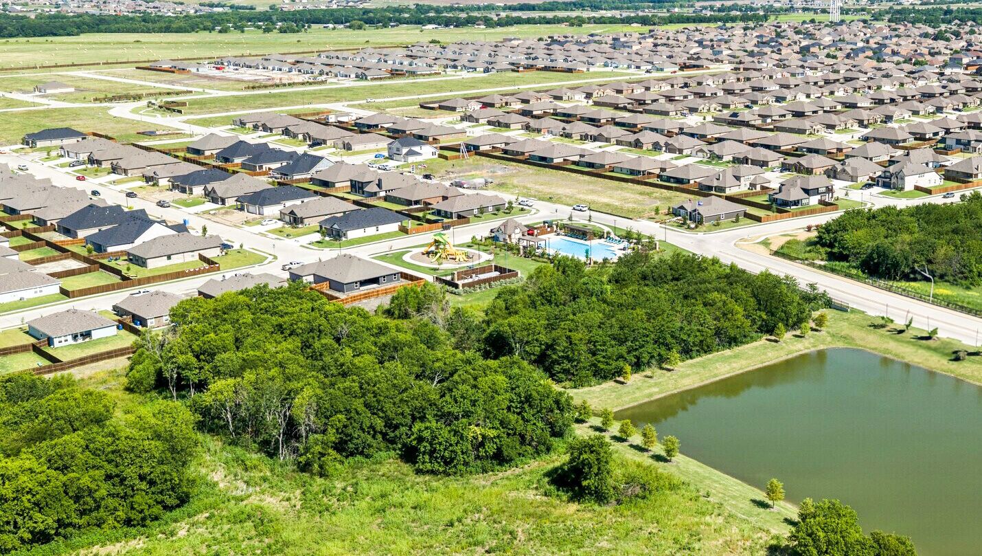 Community aerial view with pond, amenity center and homes