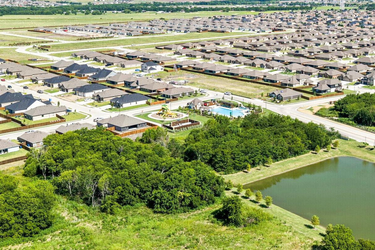 Community aerial view with pond, amenity center and homes
