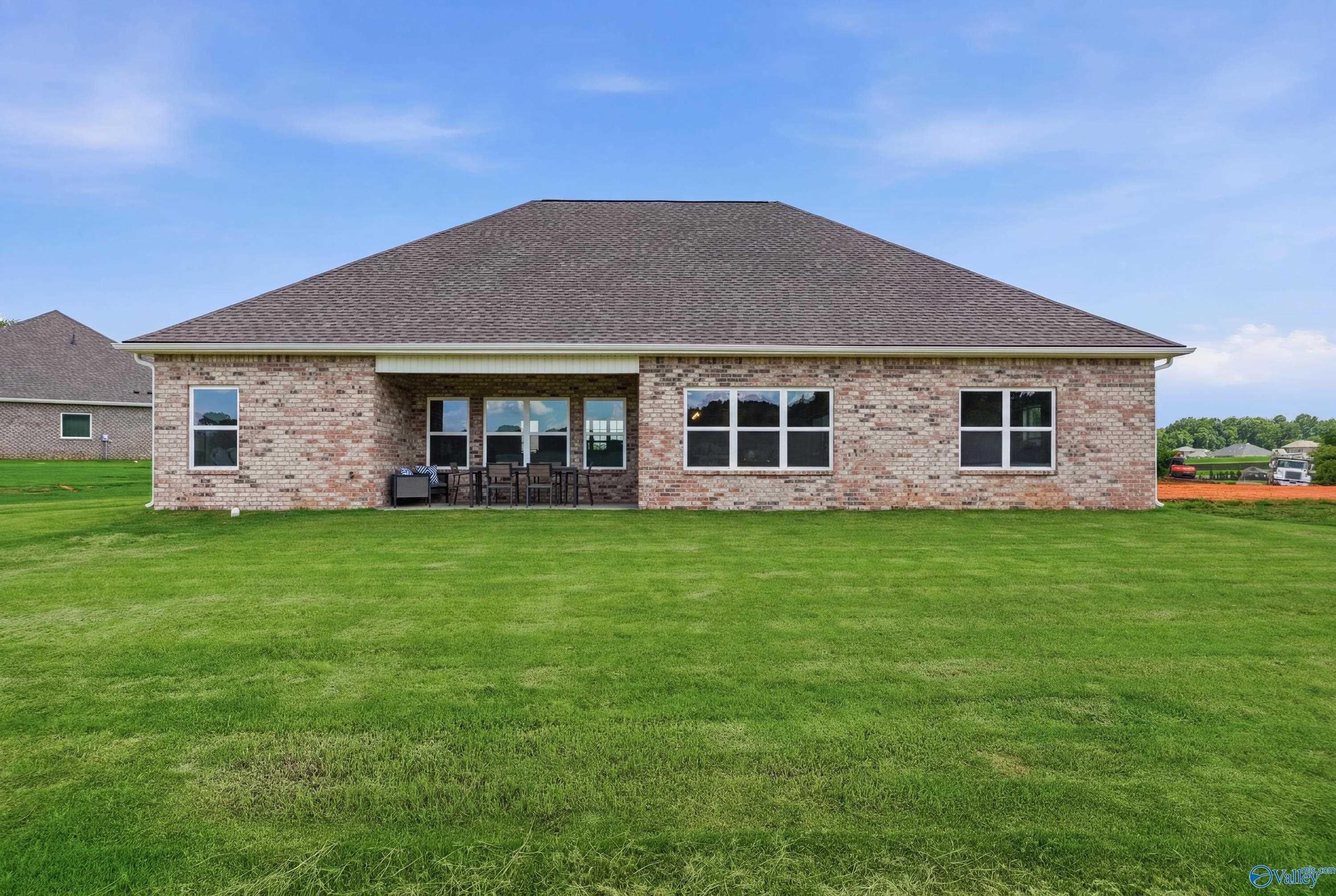 Rear view of The Finleigh floor plan by Davidson Homes featuring a brick exterior and covered patio in Riverton Preserve.