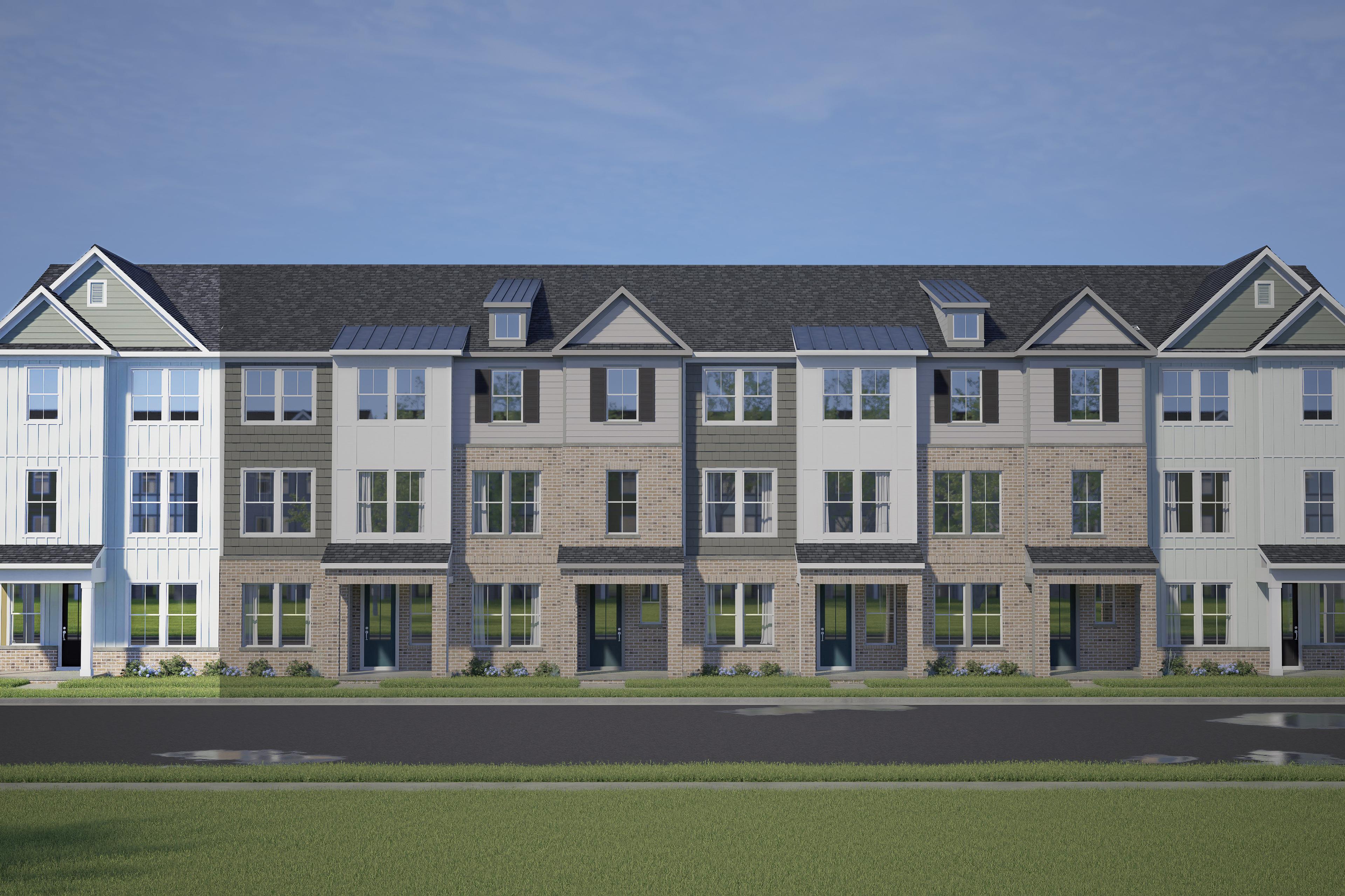 Row of modern 3-story The Mitchell townhomes by Davidson Homes in Knightdale NC, featuring varied siding, gabled roofs, and 2-car garages