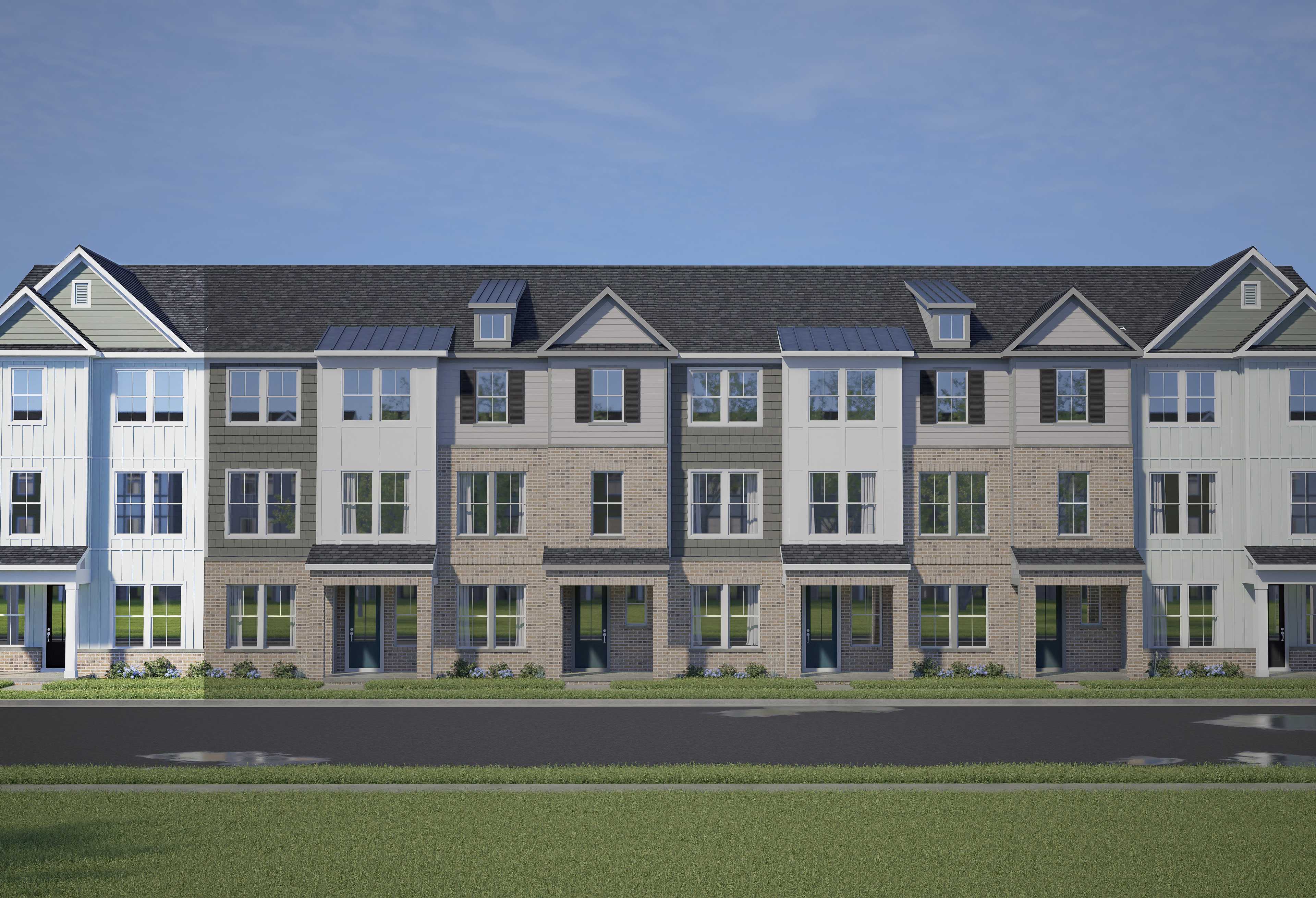 Row of modern 3-story The Mitchell townhomes by Davidson Homes in Knightdale NC, featuring varied siding, gabled roofs, and 2-car garages