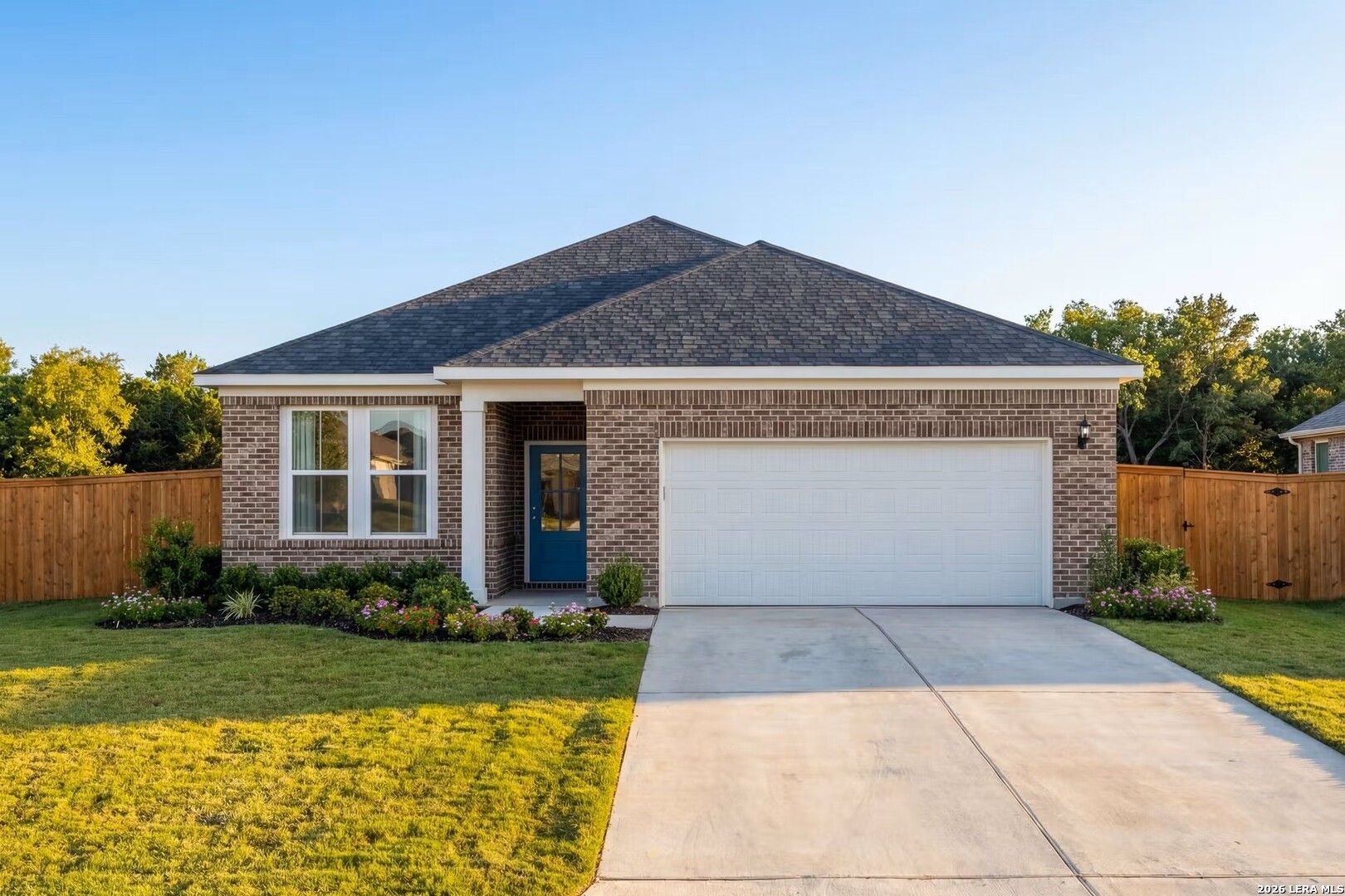 Single-story Glenwood E home by Davidson Homes with brick exterior and 2-car garage in Comanche Ridge, San Antonio, Texas.