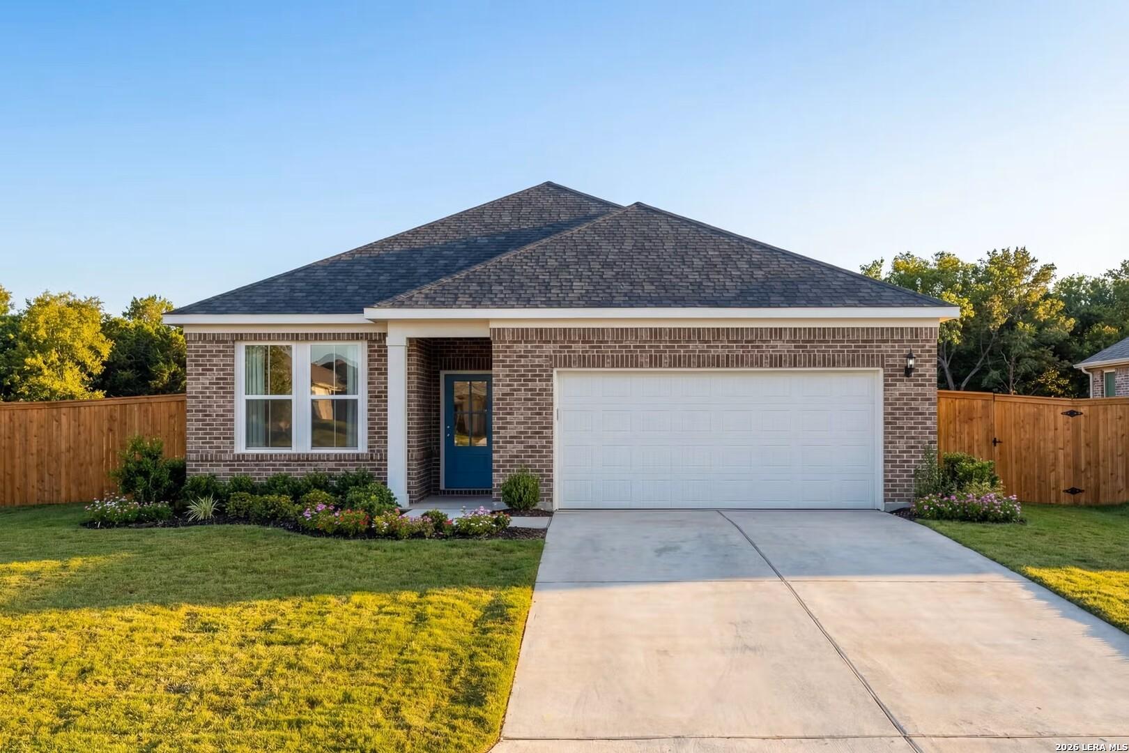 Single-story Glenwood E home by Davidson Homes with brick exterior and 2-car garage in Comanche Ridge, San Antonio, Texas.