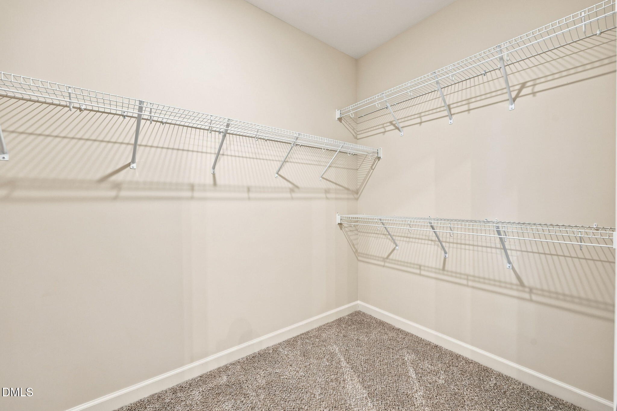 Spacious walk-in closet with wire shelving in The Magnolia B floor plan at Retreat at North Main, Lillington, NC.