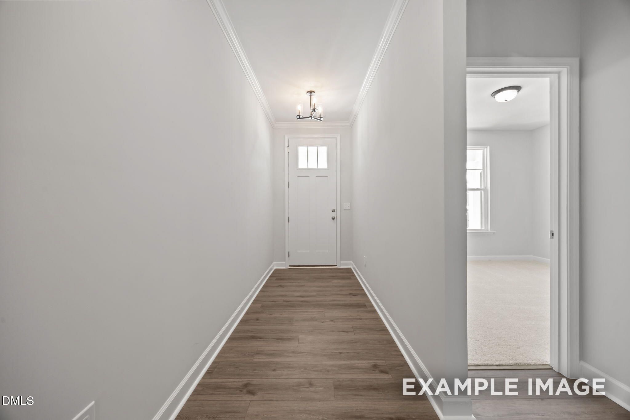 Bright foyer with luxury vinyl plank flooring and chandelier in Davidson Homes The Beech plan at Wendell Ridge, NC
