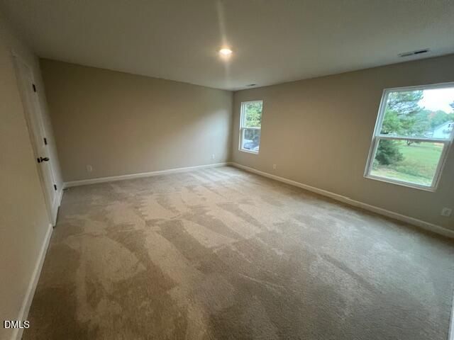 Spacious carpeted bedroom with natural light and backyard views in Davidson Homes The Willow D, Wellers Knoll, Lillington, NC