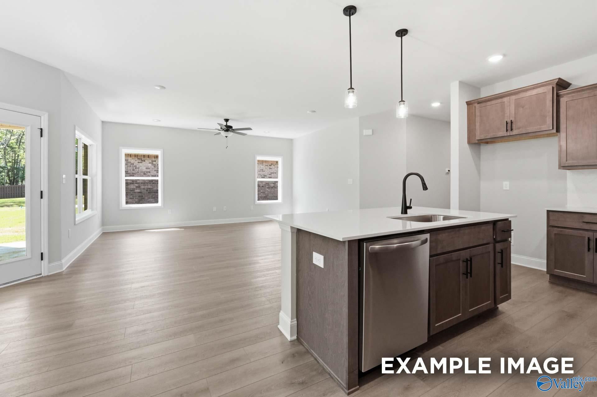 Open-concept kitchen and living area in The Franklin C floor plan at The Highlands, Arab, Alabama.