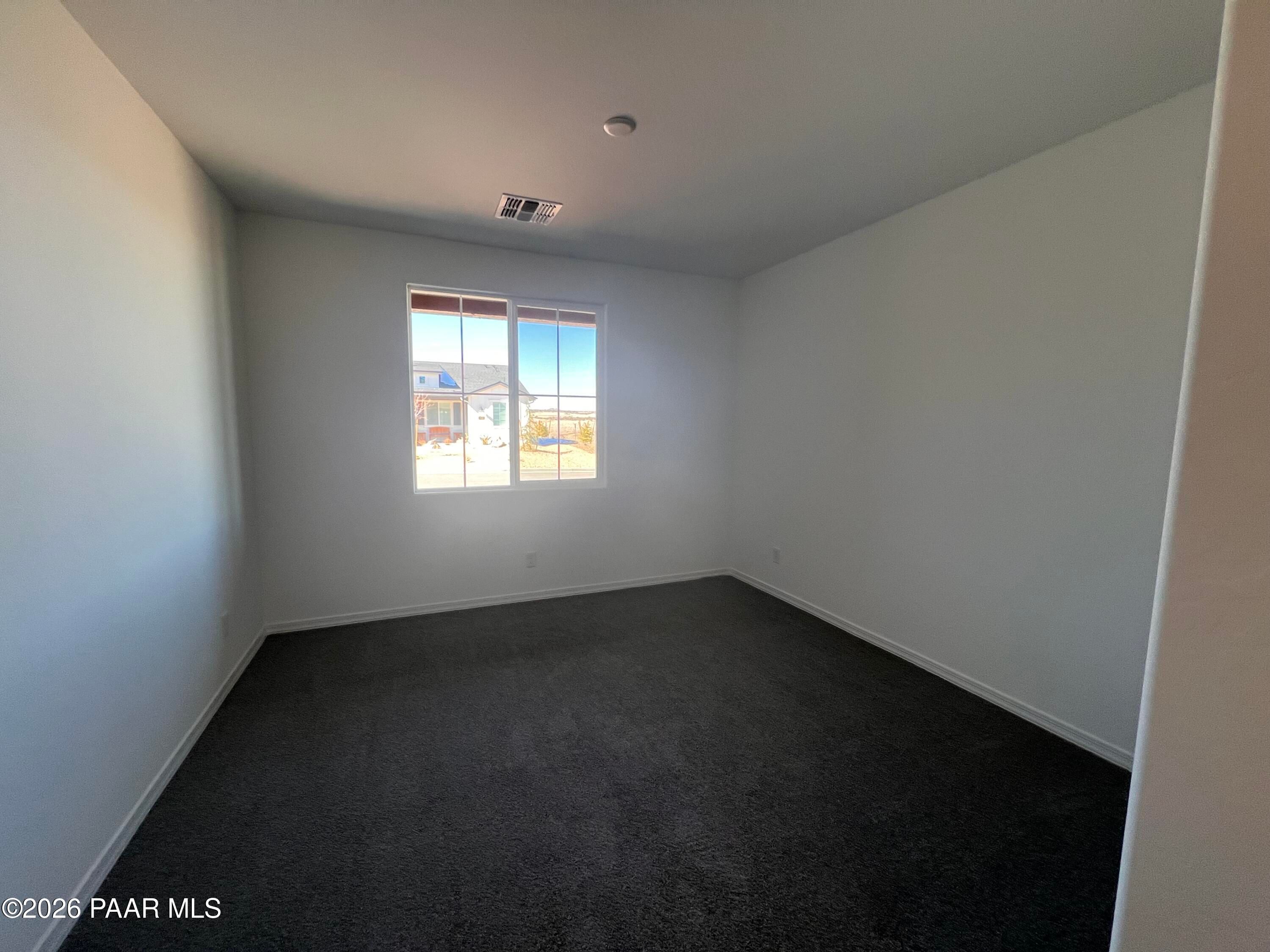 Empty secondary bedroom with large window and desert view in 3-bedroom Sunrise II A home, Davidson Homes, Prescott, Arizona