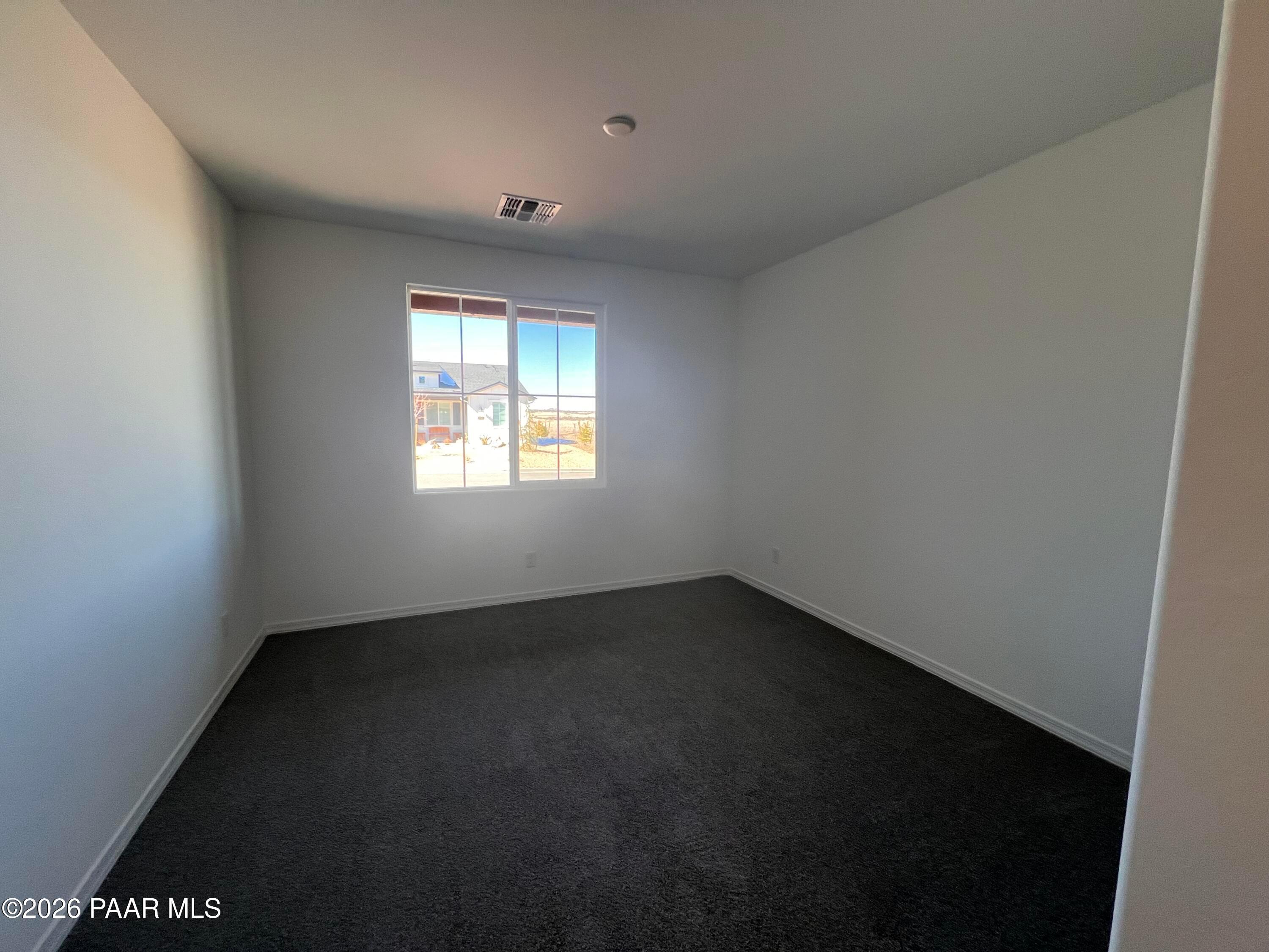 Empty secondary bedroom with large window and desert view in 3-bedroom Sunrise II A home, Davidson Homes, Prescott, Arizona