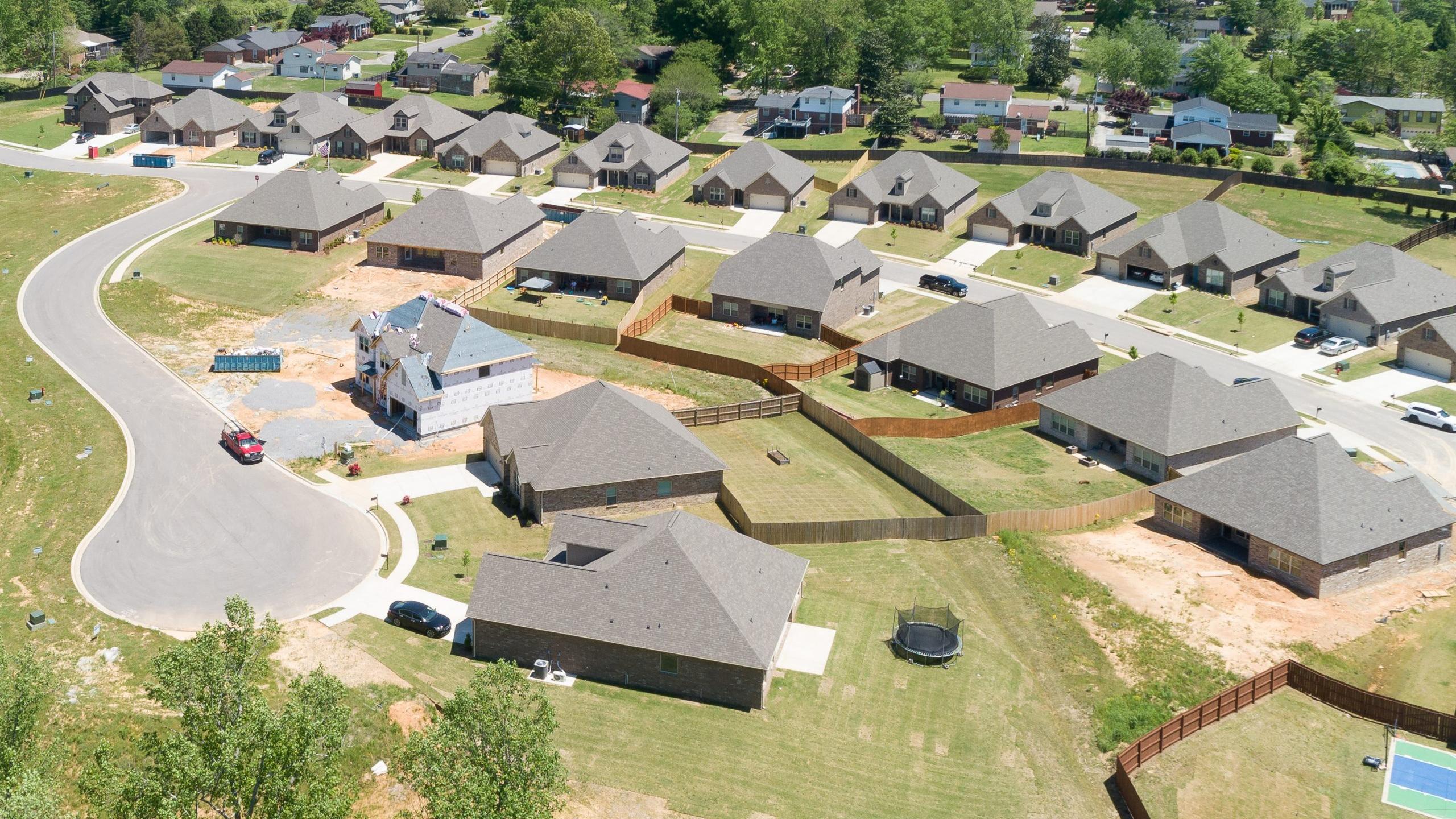 Aerial view of new single-family homes in Stone Creek Phase II, Cullman Alabama by Davidson Homes with curved roads and wooded lots