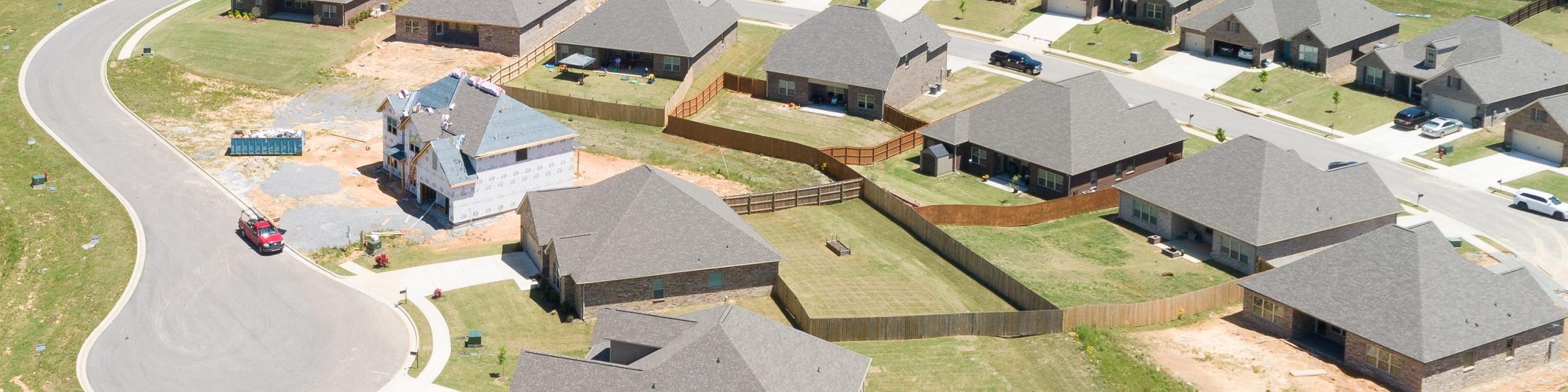 Aerial view of new single-family homes in Stone Creek Phase II, Cullman Alabama by Davidson Homes with curved roads and wooded lots