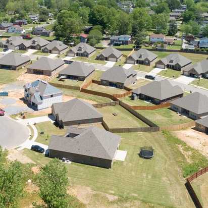 Aerial view of new single-family homes in Stone Creek Phase II, Cullman Alabama by Davidson Homes with curved roads and wooded lots