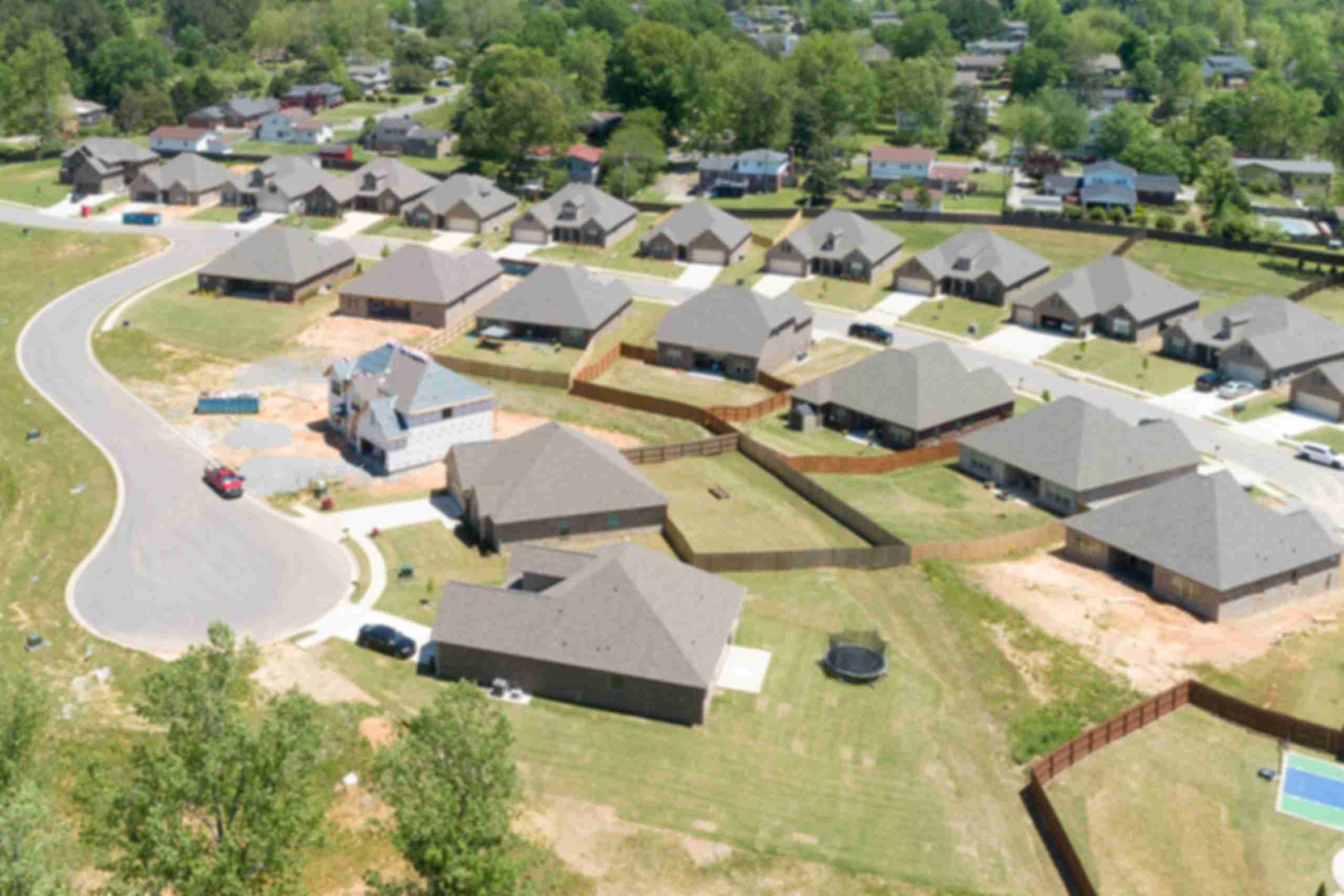 Aerial view of new single-family homes in Stone Creek Phase II, Cullman Alabama by Davidson Homes with curved roads and wooded lots