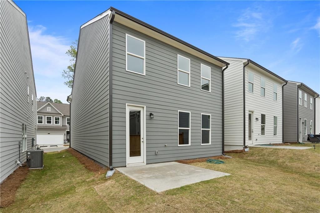 Modern gray two-story exterior with windows and front door, 2-car garage in The Village at Shallowford, Kennesaw, Georgia - Davidson Homes The Cary B