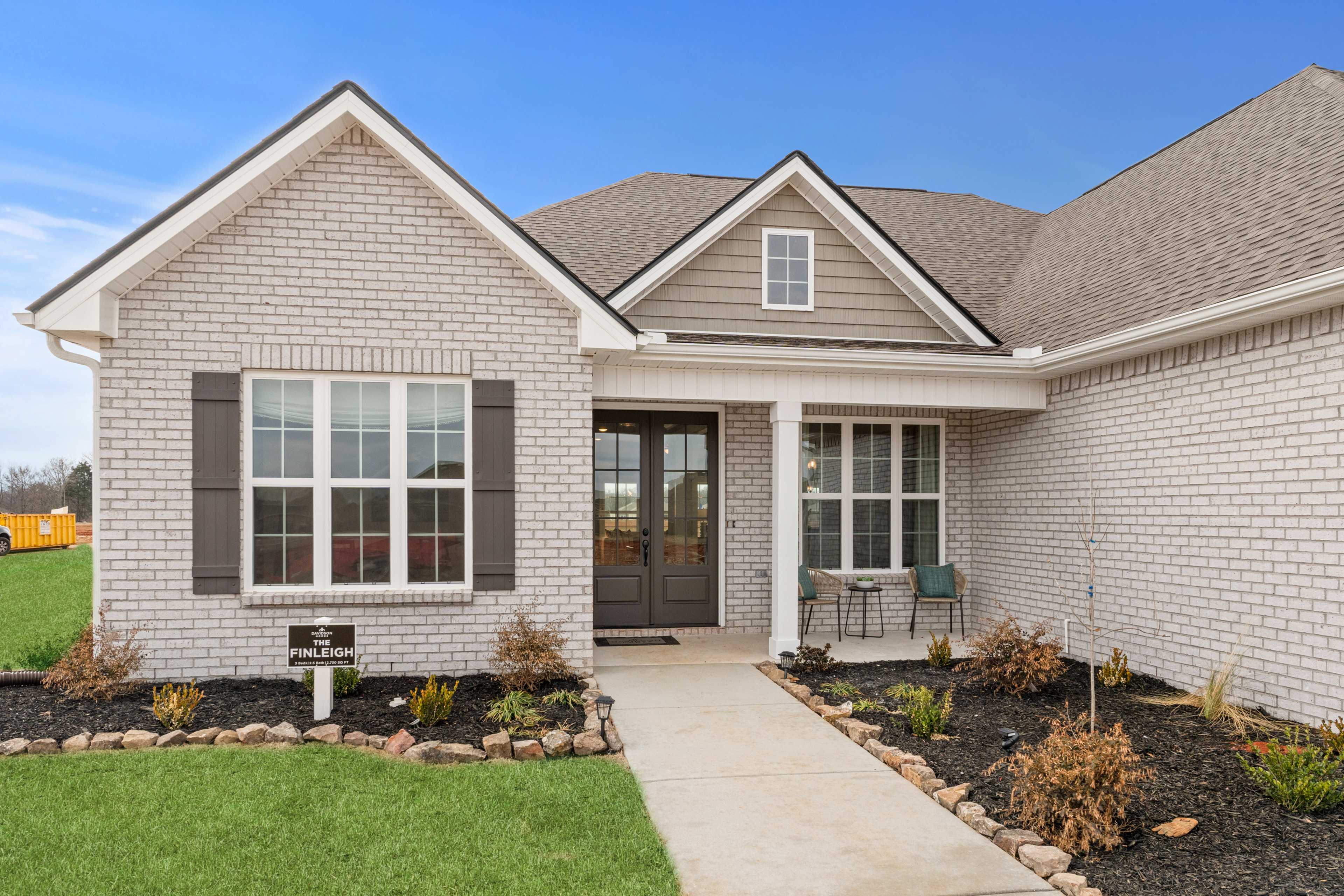 Modern brick home exterior at Briercreek in Meridianville, Alabama with covered porch and landscaped yard
