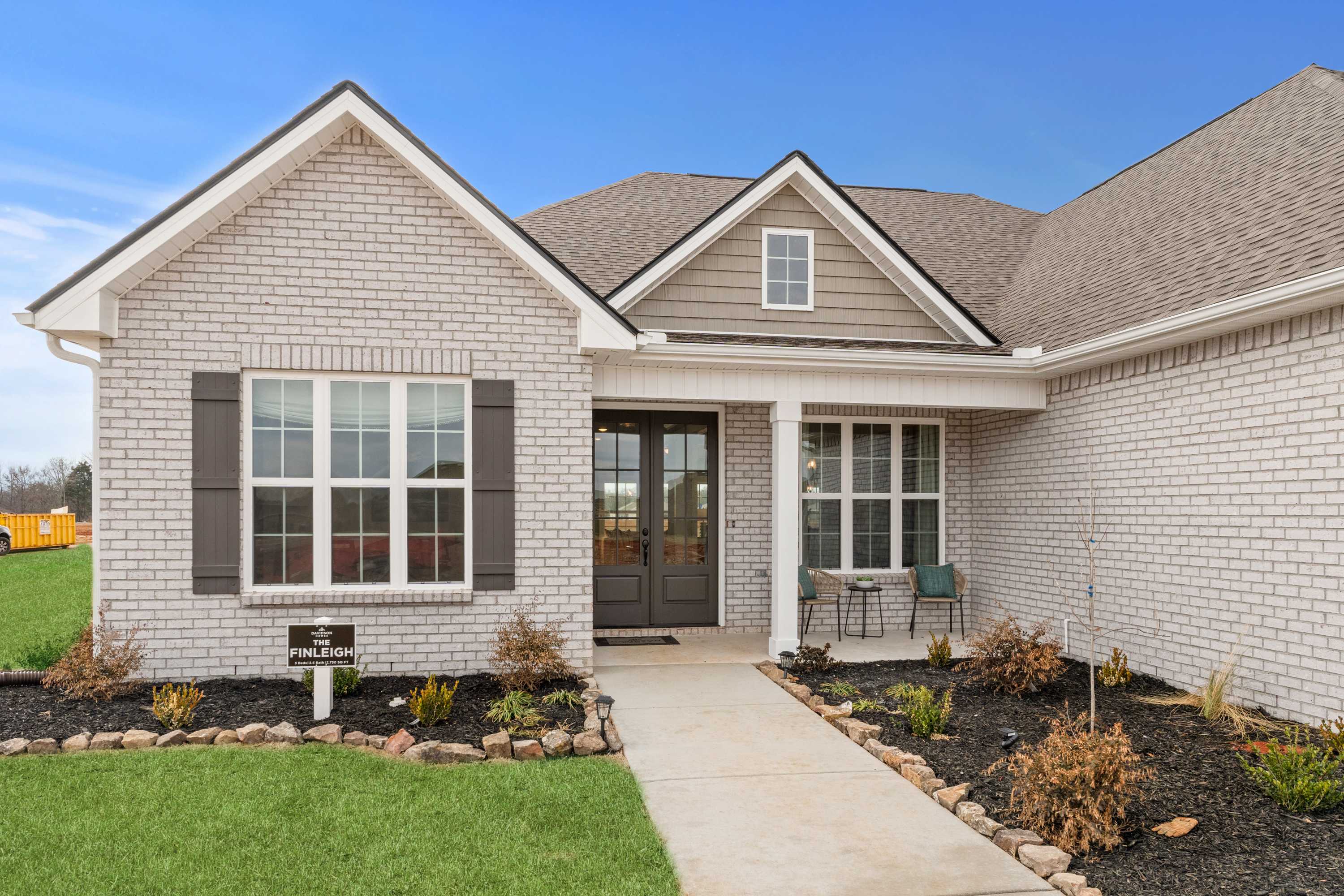 Modern brick home exterior at Briercreek in Meridianville, Alabama with covered porch and landscaped yard