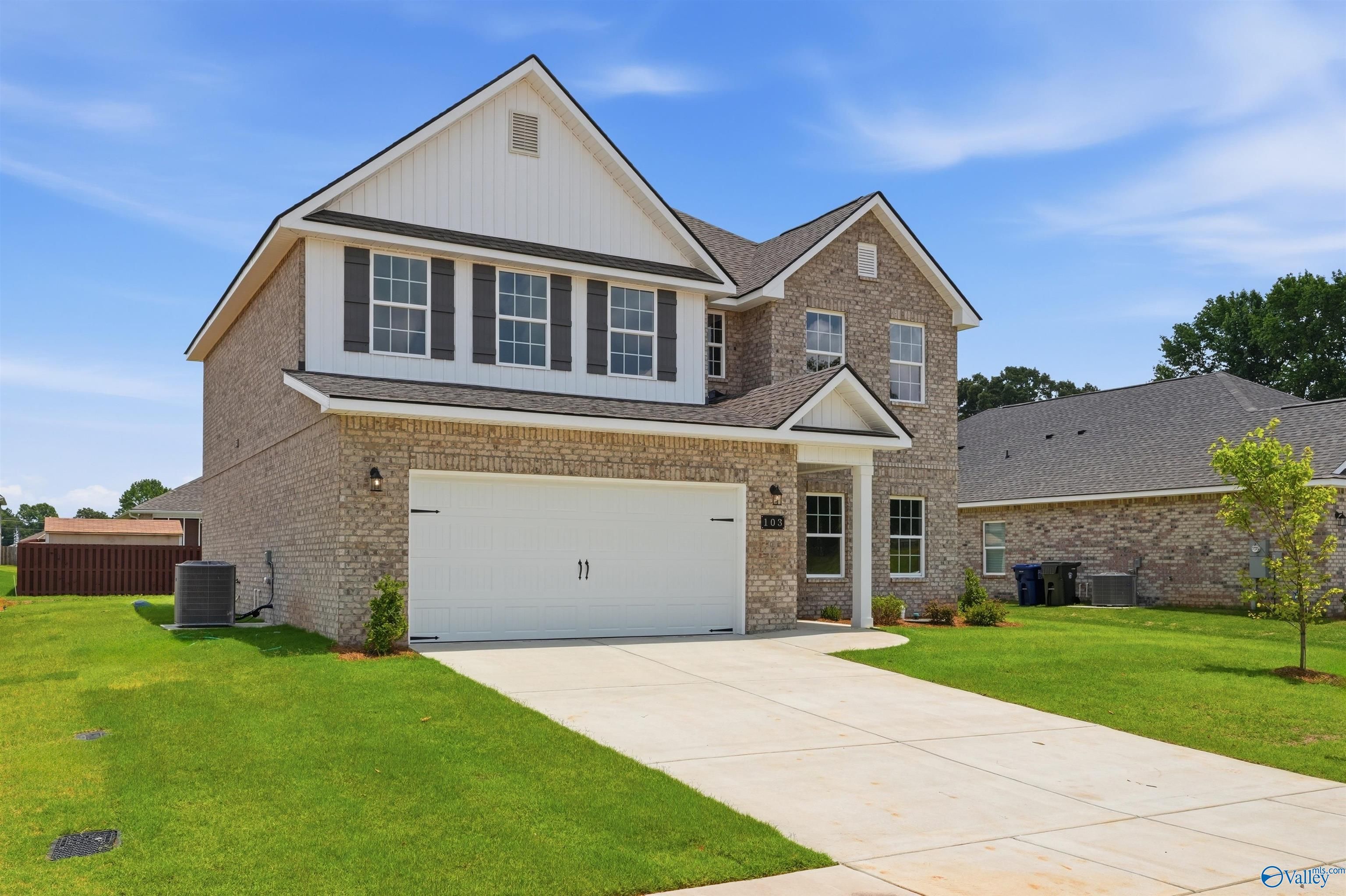 Two-story brick Shelby A floor plan home with a 2-car garage in Wood Trail, Toney, Alabama.
