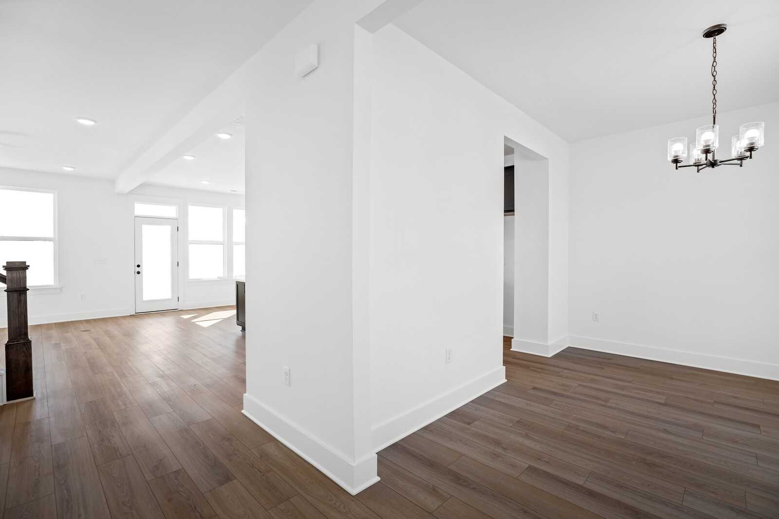 Grand entry foyer with hardwood floors, staircase, and chandelier in The Willow B 4-bedroom home, Gallatin, Tennessee