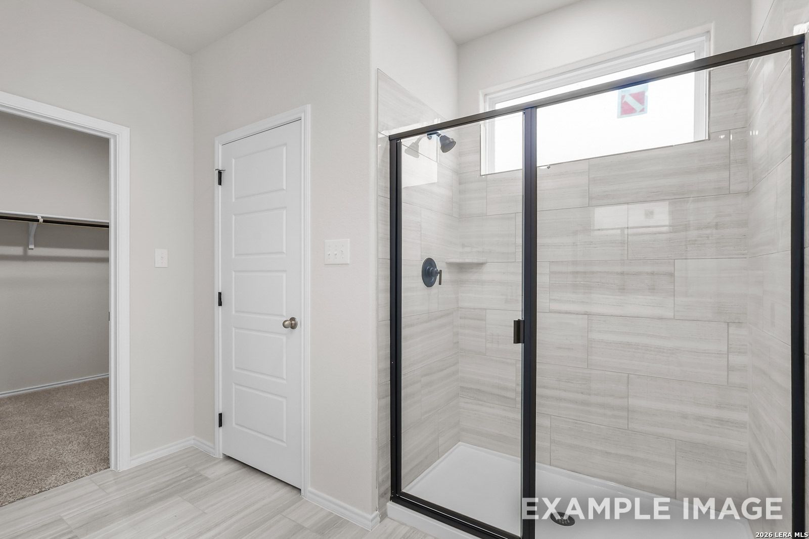 Tiled walk-in shower with glass enclosure in The Sequoia C floor plan by Davidson Homes in Royal Crest, San Antonio.