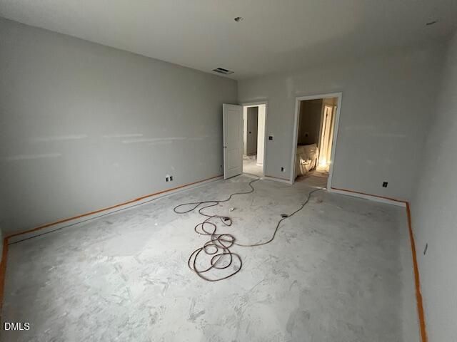 Spacious unfinished bedroom with fresh drywall and concrete floor under construction in Davidson Homes The Daphne C, Wellers Knoll, Lillington NC