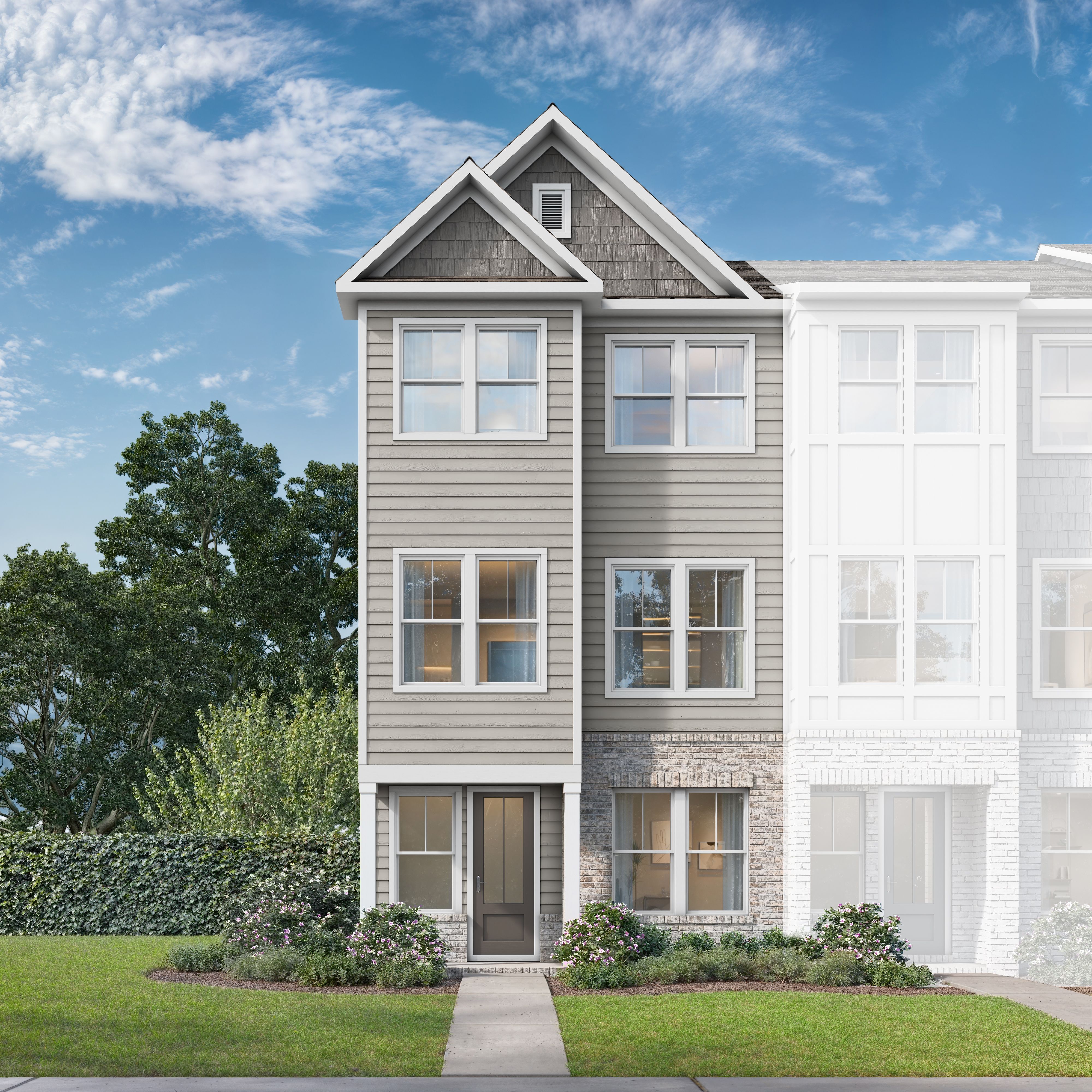 Modern 3-story duplex exterior of The Lincoln D by Davidson Homes, gray siding, brick base, windows, shrubs, in Woodstock GA