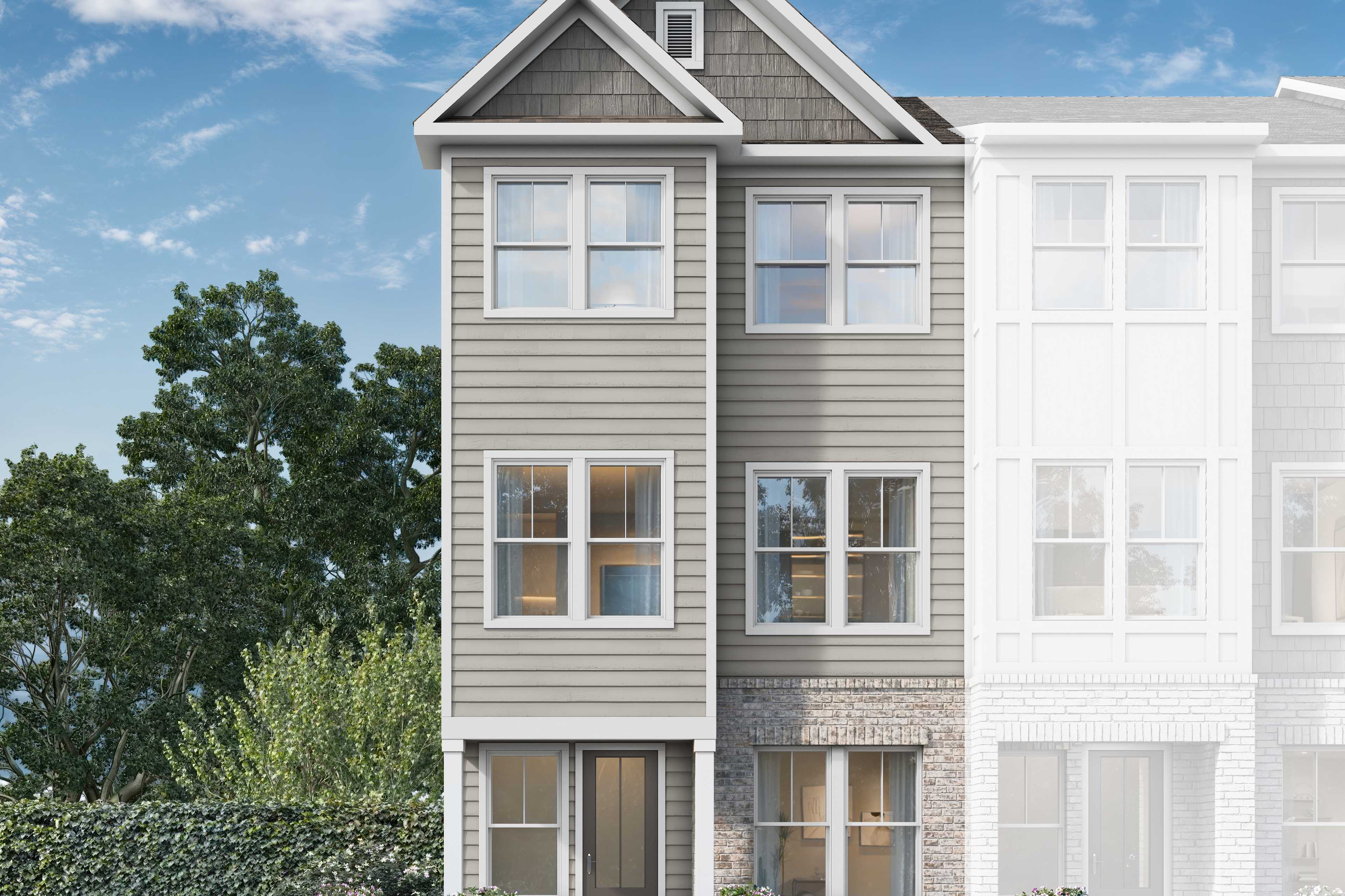 Modern 3-story duplex exterior of The Lincoln D by Davidson Homes, gray siding, brick base, windows, shrubs, in Woodstock GA