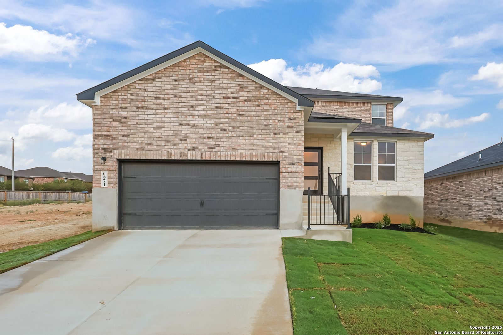 Two-story brick home with 2-car garage driveway in Comanche Ridge, San Antonio, Texas - Davidson Homes The Douglas F