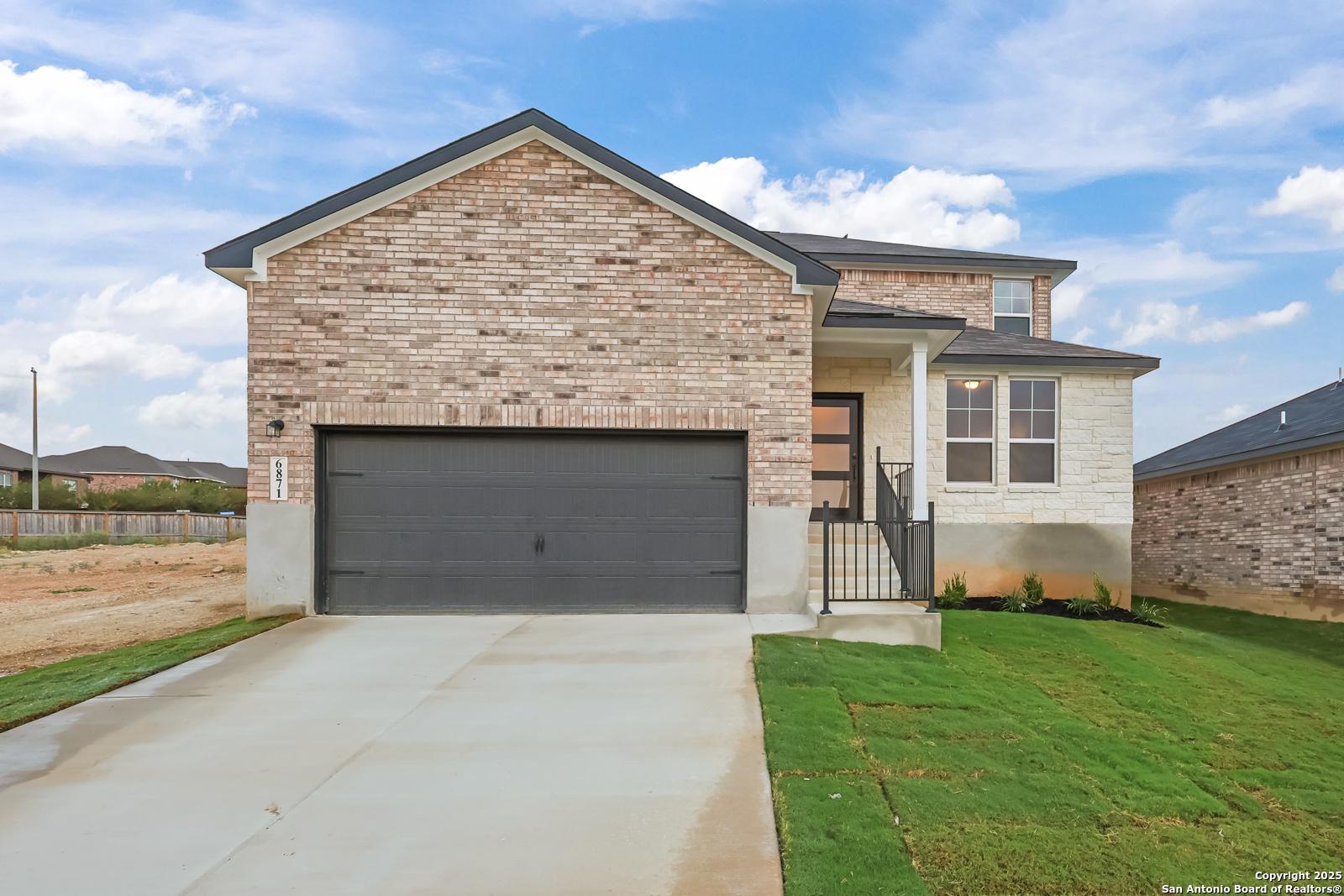Two-story brick home with 2-car garage driveway in Comanche Ridge, San Antonio, Texas - Davidson Homes The Douglas F