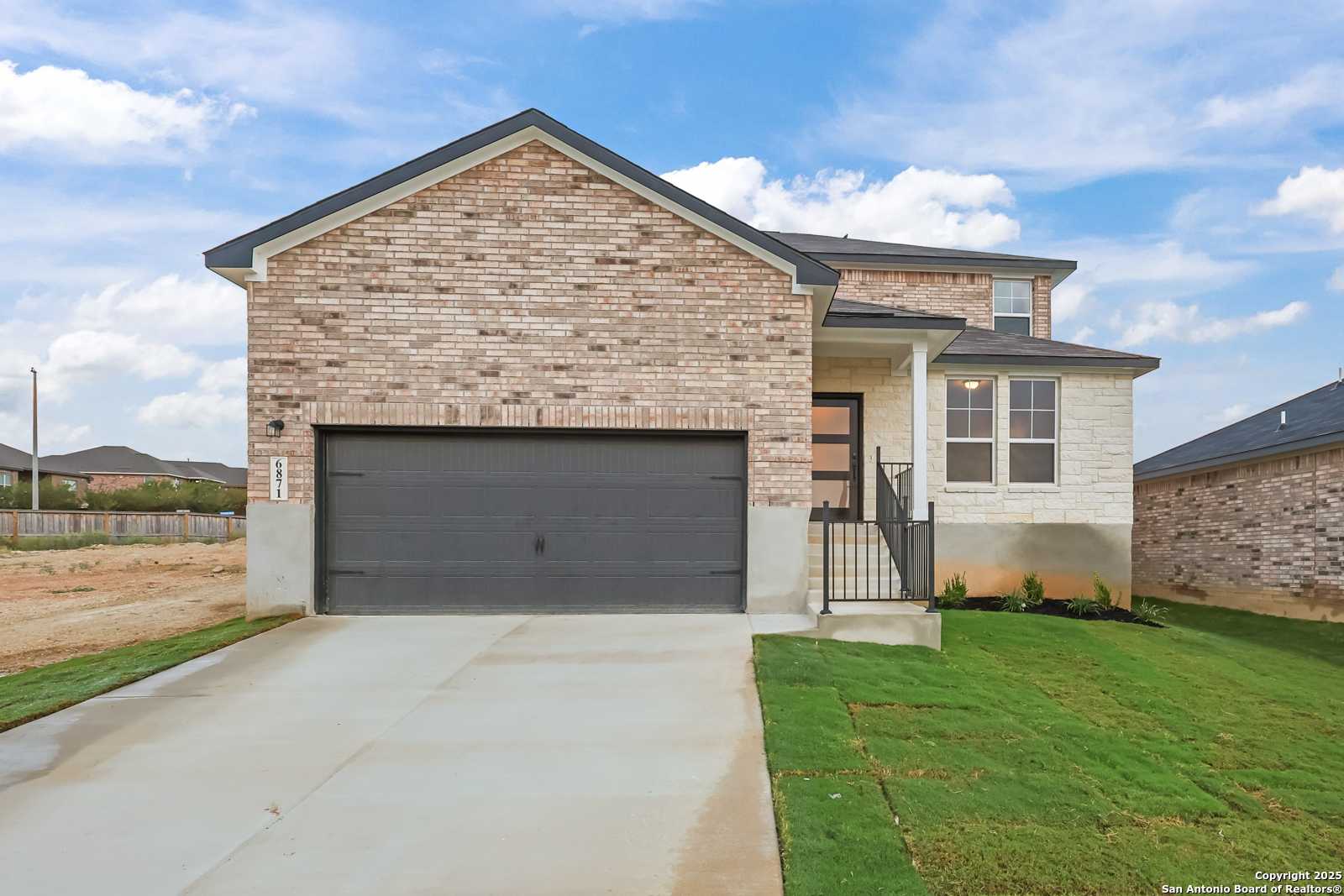 Two-story brick home with 2-car garage driveway in Comanche Ridge, San Antonio, Texas - Davidson Homes The Douglas F