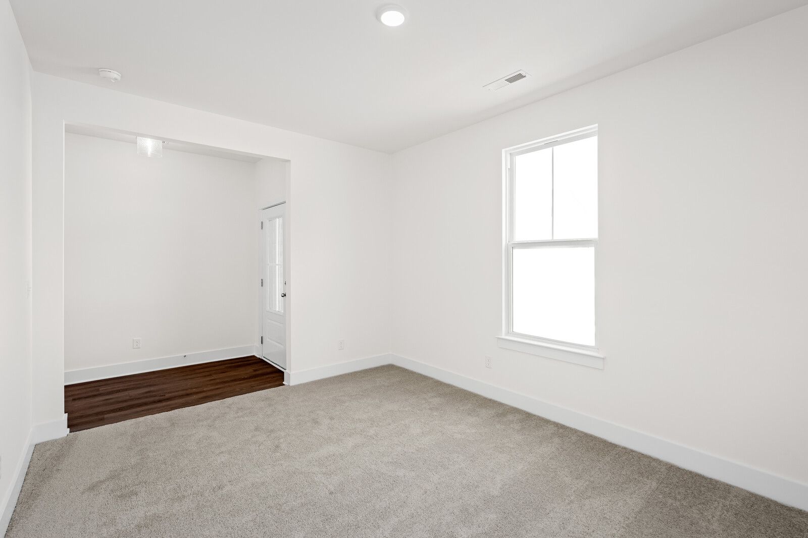 Bright, carpeted bedroom in The Cottonwood E floor plan by Davidson Homes in Gallatin, Tennessee.