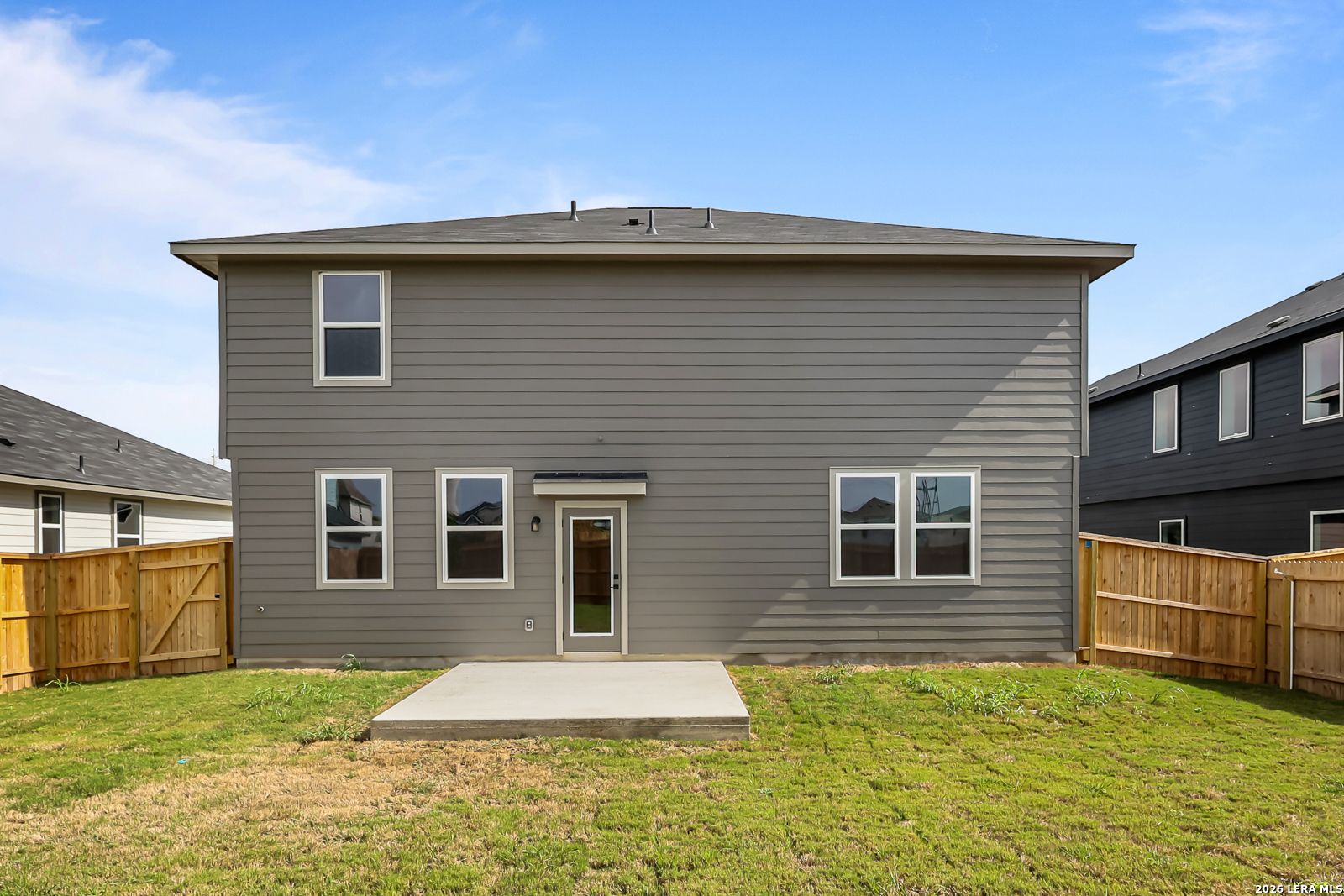 Back exterior view of The Douglas C floor plan by Davidson Homes with a concrete patio in Hannah Heights, Seguin, Texas.