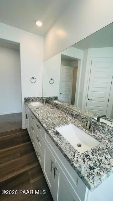 Modern bathroom vanity with dual sinks, granite countertops, and white cabinetry in Davidson Homes The Summit A, Prescott.