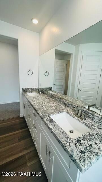 Modern bathroom vanity with dual sinks, granite countertops, and white cabinetry in Davidson Homes The Summit A, Prescott.